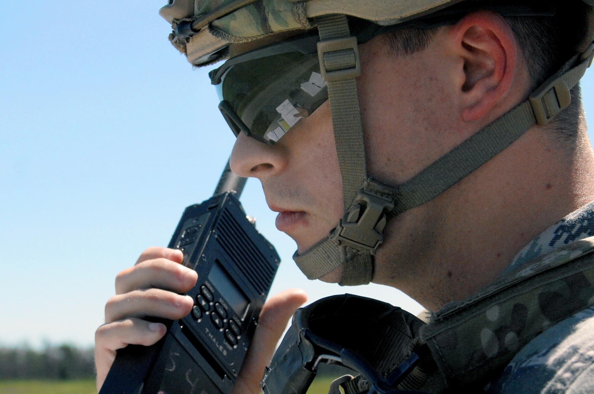 U.S. Air Force 1st Lt. Nathan Maxton, 15th Air Support Operations Squadron air liaison officer, communicates with a pilot during a week of training at the Dare County Bomb Range in Stumpy Point, N.C., Aug. 26, 2013.  Maxton and other JTACs called in a variety of commands to multiple F-15E Strike Eagles to ensure all targets were destroyed.  (U.S. Air Force photo by Airman 1st Class Brittain Crolley)