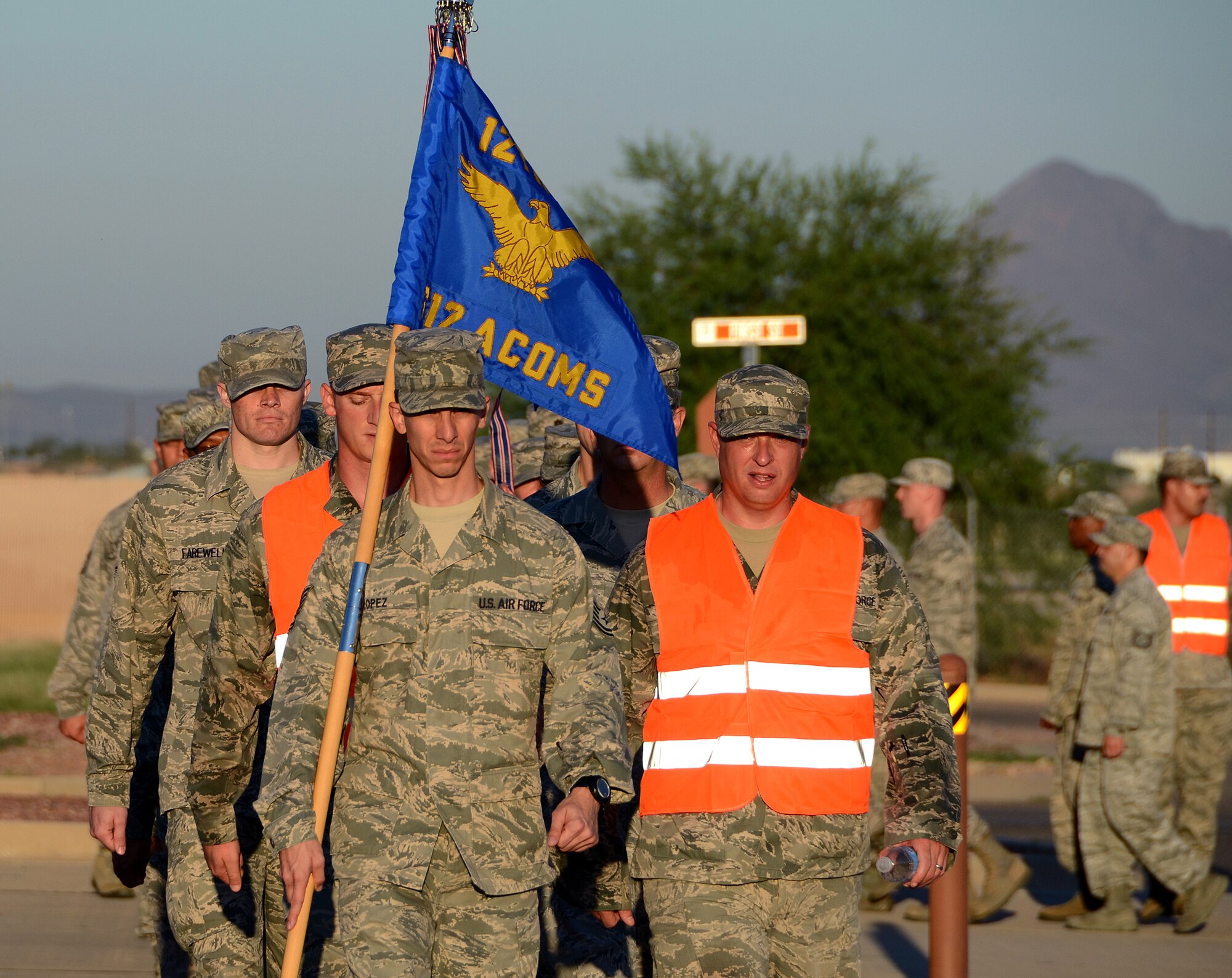 Tech. Sgt. Edwin Lopez, member of the 612th Air Communication Squadron, carries the guidon during a  march around Davis-Monthan AFB, Ariz. in remembrance of the 9/11 victims, Sept. 11, 2013.  The members stopped throughout the march during key moments in time to honor those who lost their lives during the attacks. (USAF photo by Staff Sgt. Heather Redman/Released)
