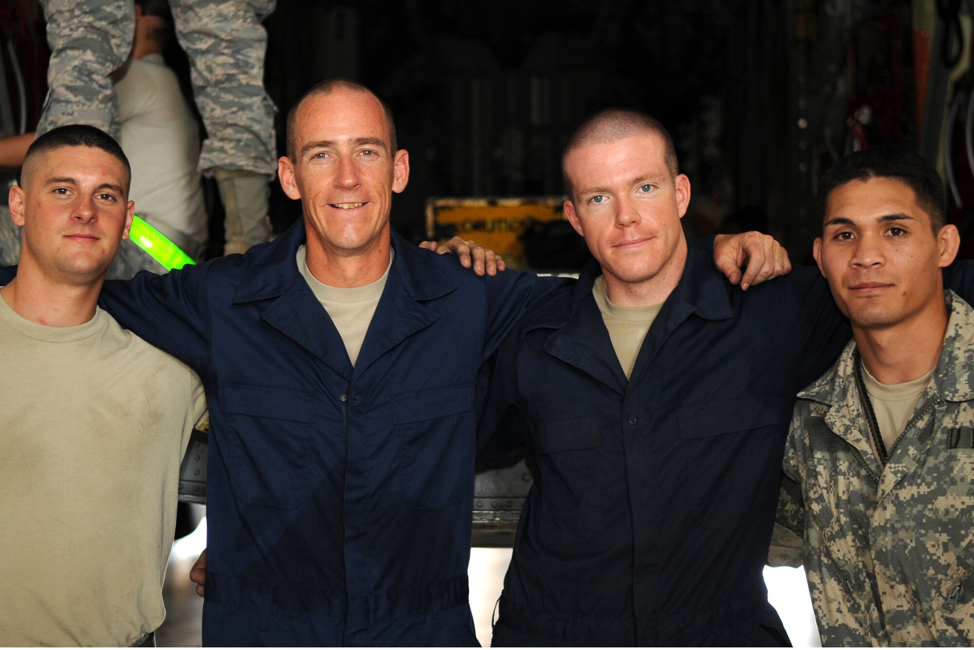 (From left to right) U.S. Air Force Airman 1st Class Scott Thompson, Col. Jeffrey Brown, Senior Airman Sean Hopkins and Staff Sgt. Joshua Obena pose for a group photo Sept. 6, 2013, at the Global Reach for America hangar on Dyess Air Force Base, Texas. Col. Brown, 317th Airlift Group commander, spent time working with Hopkins after losing a physical training challenge he offered up to his entire group. Brown stated that any Airman who beat him in a run, he would do their job for two hours. Hopkins ran his mile-and-a-half in 8:17, while Brown finished with an 8:51. (U.S. Air Force photo by Senior Airman Shannon Hall/Released)
