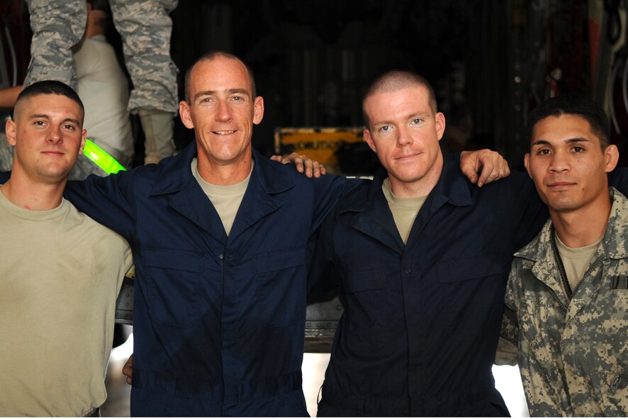 (From left to right) U.S. Air Force Airman 1st Class Scott Thompson, Col. Jeffrey Brown, Senior Airman Sean Hopkins and Staff Sgt. Joshua Obena pose for a group photo Sept. 6, 2013, at the Global Reach for America hangar on Dyess Air Force Base, Texas. Col. Brown, 317th Airlift Group commander, spent time working with Hopkins after losing a physical training challenge he offered up to his entire group. Brown stated that any Airman who beat him in a run, he would do their job for two hours. Hopkins ran his mile-and-a-half in 8:17, while Brown finished with an 8:51. (U.S. Air Force photo by Senior Airman Shannon Hall/Released)