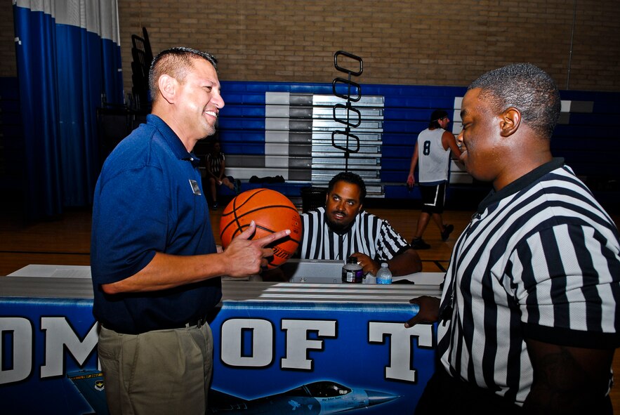 John Acosta, 56th Force Support Squadron Fitness Center sports director, speaks with referees about intramural basketball rules during halftime of a game Monday at the Luke Air Force Base Bryant Fitness Center gym. (U.S. Air Force photo/Senior Airman David Owsianka)