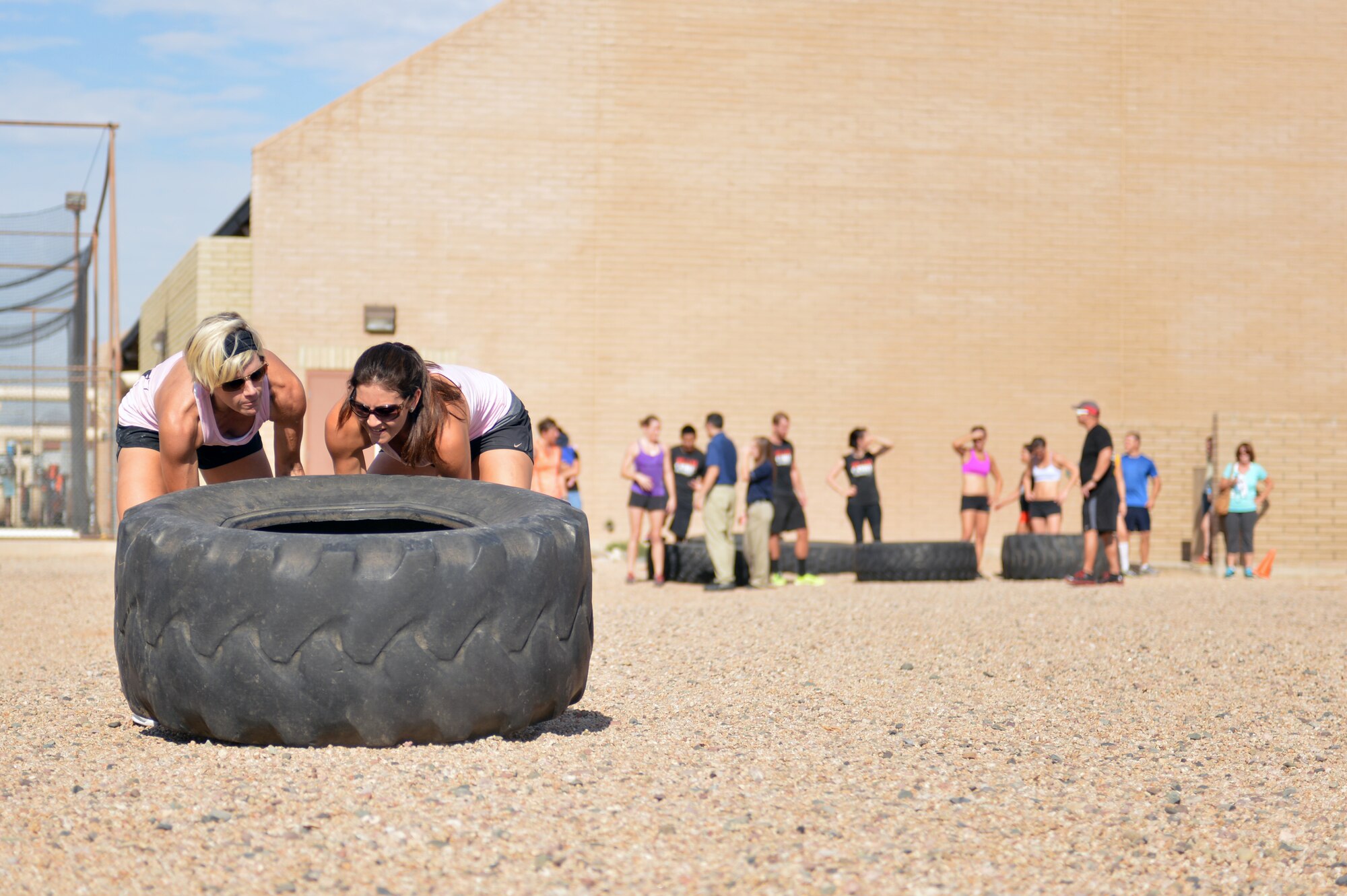 Team Charlie members compete in a 50-foot tractor tire event. The final stage also included a 500-meter row, burpees, a fire hose run and a victim carry. (U.S. Air Force photo/Senior Airman William Branch)