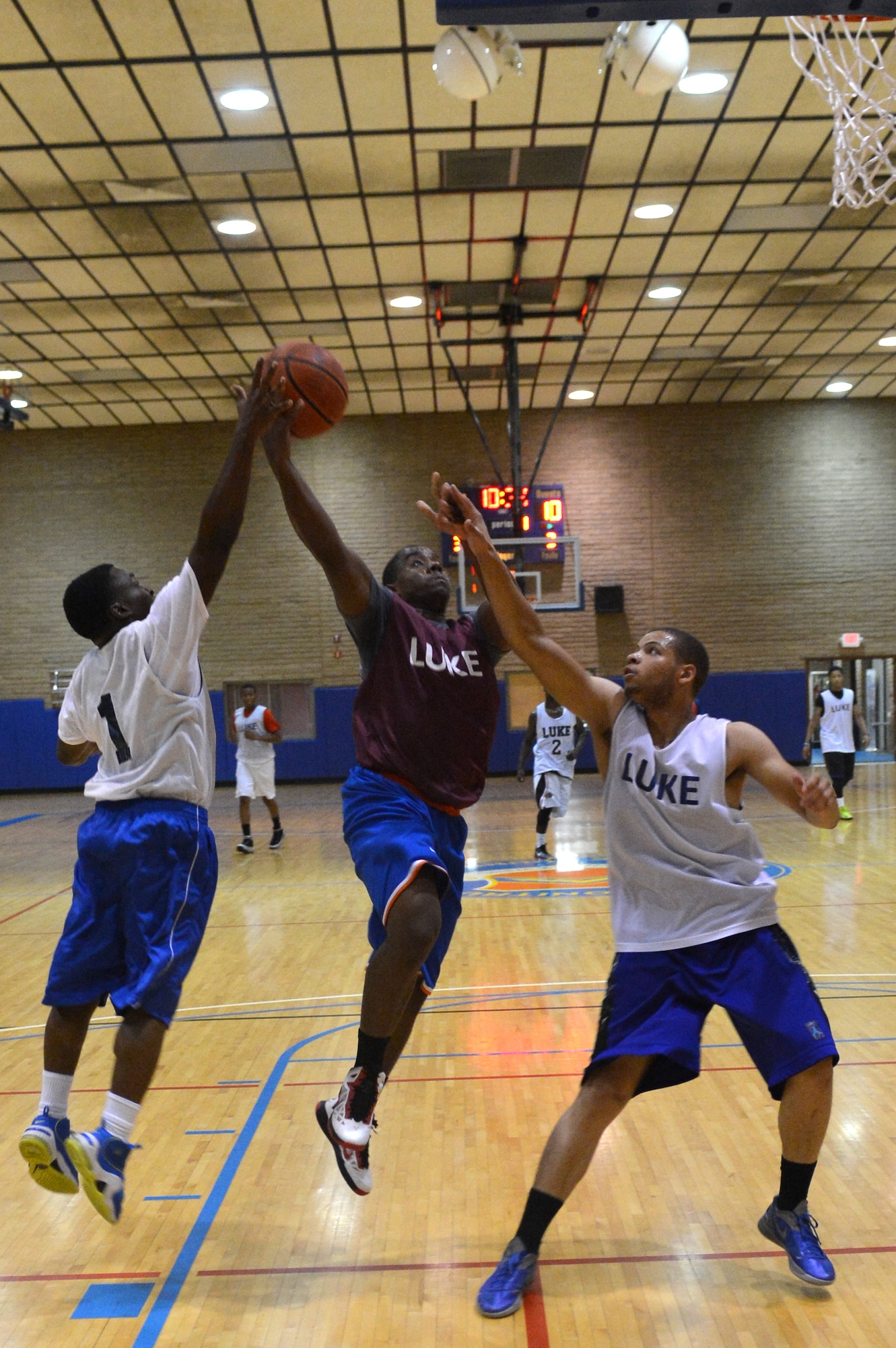 David Hicks, center, 56th Security Forces Squadron, attempts to drive in the lane Sept. 3 during a playoff intramural basketball game at Luke Air Force Base. LRS defeated SFS 56-48. (U.S. Air Force photo/Airman 1st Class Devante Williams)