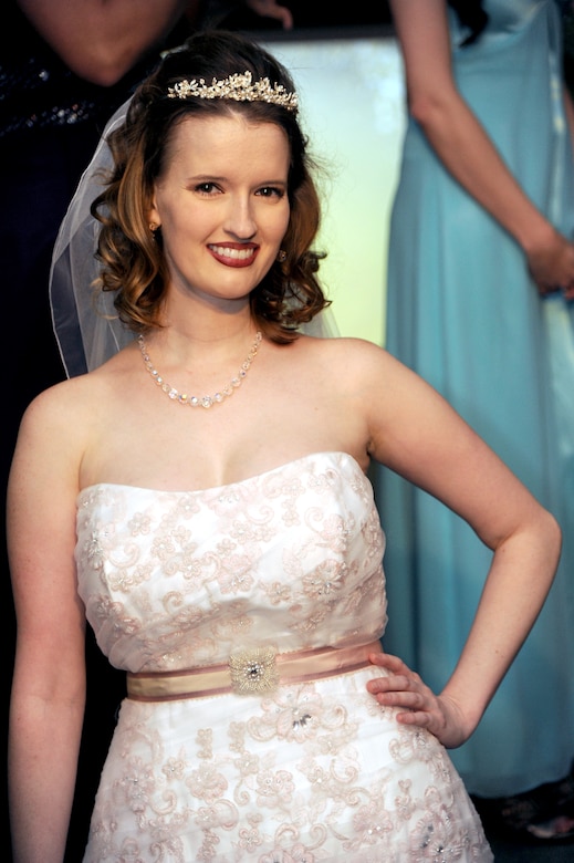 Charly Swiger-Peterson, fashion show model, strikes a pose in a Cinderella’s Closet wedding dress at the closing of the B-2 Fabulous Fashion Show at Whiteman Air Force Base, Mo., Sept. 6, 2013. Donations of dresses, shoes and jewelry are always accepted at the Cinderella’s Closet, and can be made at the Airman’s Attic, open Tuesdays and Fridays from 10 a.m. to 2 p.m. (U.S. Air Force photo by Airman 1st Class Shelby R. Orozco/Released)