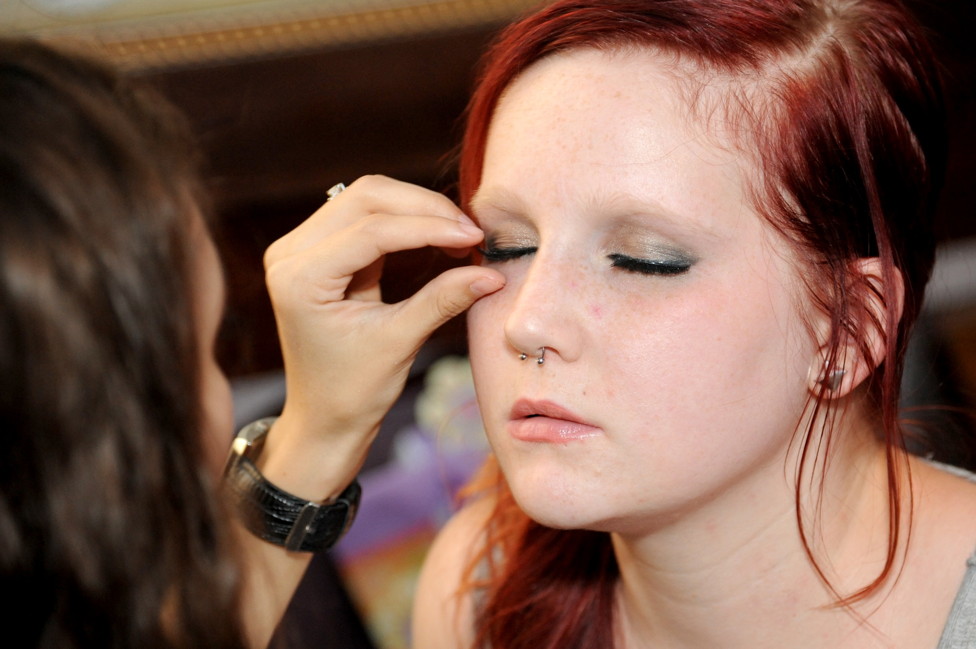 Ashlie Schlimgen, fashion show model, has her eyelashes touched up before the B-2 Fabulous Fashion Show at Whiteman Air Force Base, Mo. Sept. 6, 2013. While some models did their own hair and makeup, there were volunteers ready with curling irons and makeup kits to help the women feel like real-life princesses. (U.S. Air Force photo by Airman 1st Class Shelby R. Orozco/Released)
