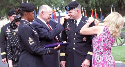 Maj. Gen. Perry Wiggins, deputy commanding general, U.S. Army North (Fifth Army), smiles as his father, Lamar, and wife, Annette, tackle pinning lieutenant general rank on him during his promotion ceremony Sept. 4 at the historic Quadrangle. Immediately following the promotion, Wiggins assumed command of Army North during a change of command ceremony. (Army photo by Staff Sgt. Corey Baltos, U.S. Army North Public Affairs)