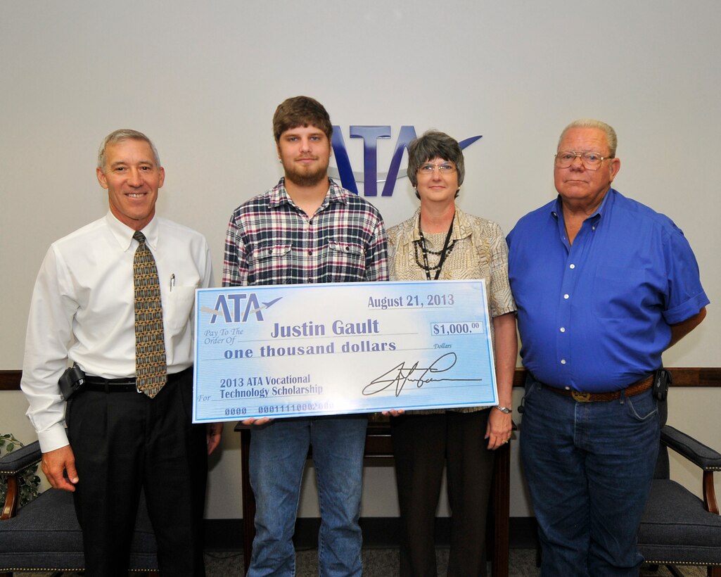 Justin Gault (second from left) accepts a $1,000 ATA Vocational Technology Scholarship from ATA Deputy General Manager Phil Stich (left). Justin is joined by his mother and ATA employee Sonia Gault (third from left) and father Ronnie Gault. (Photo by Jacqueline Cowan)