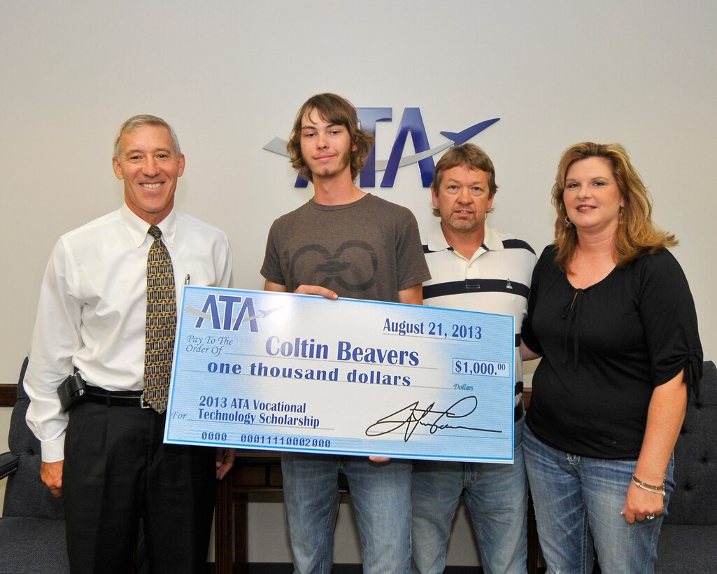 Coltin Beavers (second from left) accepts a $1,000 ATA Vocational Technology Scholarship from ATA Deputy General Manager Phil Stich (left). Coltin is joined by his father and ATA employee Frankie Beavers (third from left) and mother Tammy Beavers. (Photo by Jacqueline Cowan)