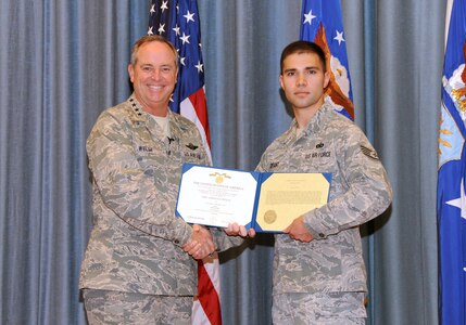 Air Force Chief of Staff Gen. Mark A. Welsh III presents the citation for the Airman's Medal to Staff Sgt. Edward Grant from the 902nd Security Forces Squadron at Joint Base San Antonio-Randolph during an All Call at the Fleenor Auditorium Sept. 12. Grant displayed exemplary courage and heroism when he risked his life to ensure 35 members' safety while assigned to Kandahar Airfield, Afghanistan. Welsh visited JBSA-Randolph Sept. 11-13. (U. S. Air Force photo by Melissa Peterson)