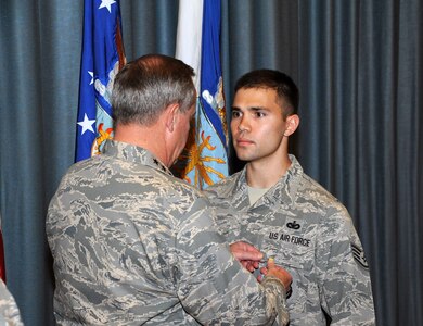 Air Force Chief of Staff Gen. Mark A. Welsh III presents the Airman's Medal to Staff Sgt. Edward Grant from the 902nd Security Forces Squadron at Joint Base San Antonio-Randolph during an All Call at the Fleenor Auditorium Sept. 12. Grant displayed exemplary courage and heroism when he risked his life to ensure 35 members' safety while assigned to Kandahar Airfield, Afghanistan. Welsh visited JBSA-Randolph Sept. 11-13. (U. S. Air Force photo by Don Lindsey)

