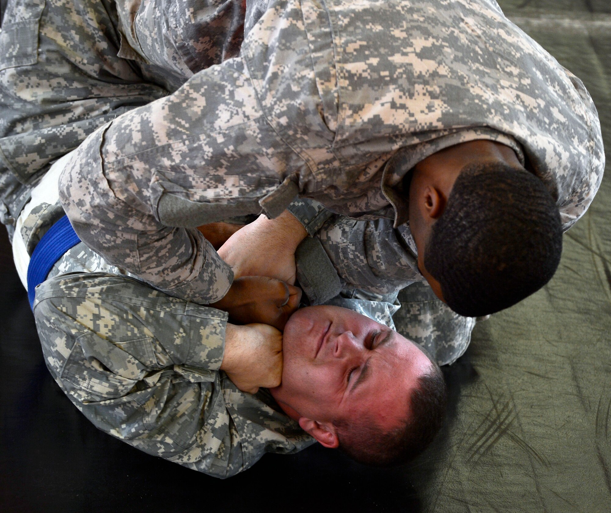 Army Sgt. Adarious Pilez, attempts to chock out Army Sgt. Nathaniel Sheehan, during a combatives tournament, Sept. 7, 2013. Kleber Kaserne Fitness Center, Germany. (U.S. Air Force photo/Airman Dymekre Allen)