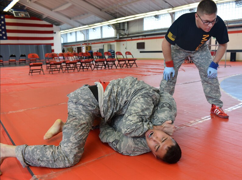 Staff Sgt. Rubuen Rivera, 10th Expeditionary Aeromedical Evacuation Flight craftsman, attempts to gain better position during a combatives tournament, Sept. 7, 2013. Kleber Kaserne Fitness Center, Germany.  (U.S. Air Force photo/Airman Dymekre Allen)