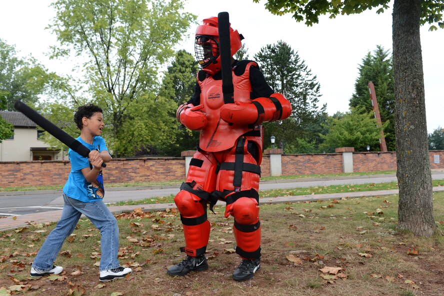 Jason Medina Jr., son of Staff Sgt. Jason Medina, U.S. Air Forces in Europe and Air Forces Africa European Central Altitude Reservation Facility technician, spars with a security forces member during the 2013 Day for Kids, Sept. 7, 2013, Ramstein Air Base, Germany. The Ramstein’s youth program and the Boys and Girls Club of America sponsored the event with the purpose of bringing parents and their children together to have a good time. (U.S. Air Force photo/Senior Airman Caitlin Guinazu)  