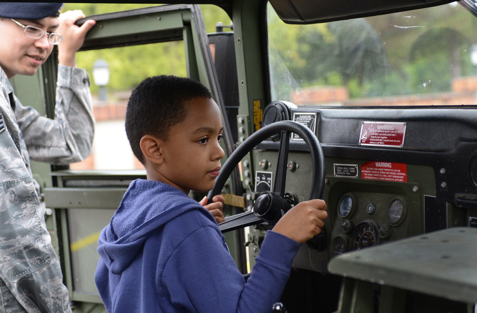 Tye Jones, son of Tech. Sgt. Shawn Jones, 86th Security Forces Squadron commanders support staff NCOIC, sits in the driver’s seat of a Humvee during the 2013 Day for Kids, Sept. 7, 2013, Ramstein Air Base, Germany. The Ramstein’s youth program and the Boys and Girls Club of America sponsored the event with the purpose of bringing parents and their children together to have a good time. (U.S. Air Force photo/Senior Airman Caitlin Guinazu)