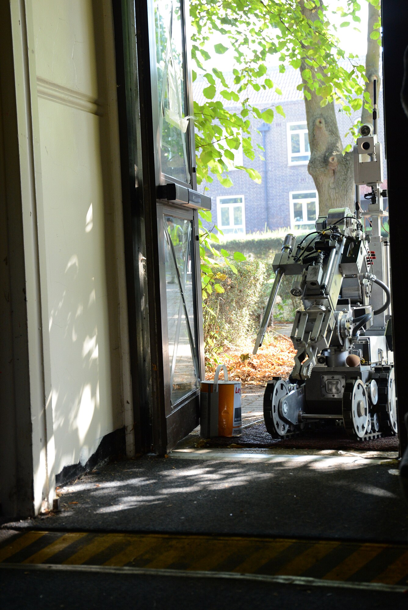 A 48th Civil Engineer Squadron Explosives Ordnance Disposal flight robot enters the facility an active-shooter was holed up in during an exercise on Royal Air Force Feltwell, England, Sept. 5, 2013. Members of the flight controlled the vehicle remotely from beyond the danger area to search for a suspicious package identified by first responders who subdued the shooter during the 48th Fighter Wing exercise. (U.S. Air Force photo by Staff Sgt. Thomas Trower/Released)
