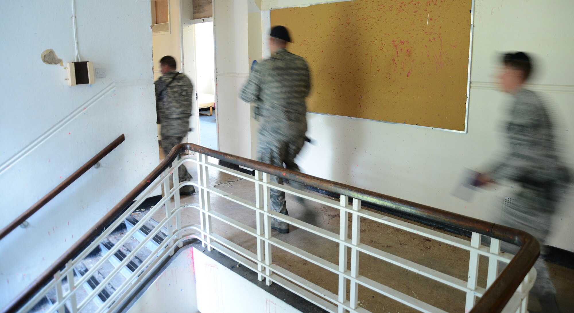 Staff Sgts. Adam Battin, Brent Bechtel and Trevor Brewer, all 48th Security Forces Squadron patrolmen, secure a building during an active-shooter exercise on Royal Air Force Feltwell, England, Sept. 5, 2013. As the first three responders at the scene, these Airmen secured the location within minutes while they were evaluated by the 48th Fighter Wing Inspection Team. (U.S. Air Force photo by Staff Sgt. Thomas Trower/Released)