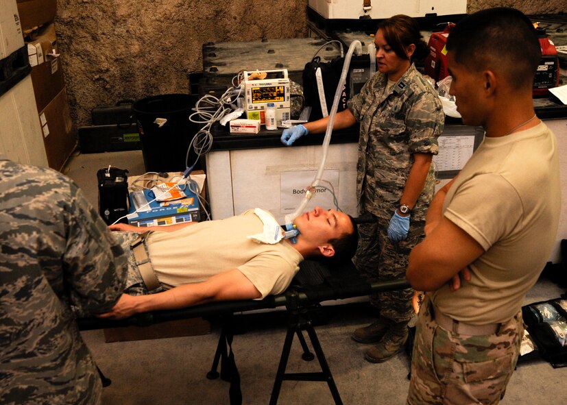 Mobile Field Surgical Team and Expeditionary Critical Care Teams talk through a patient care scenario during an exercise at the 379th Air Expeditionary Wing in Southwest Asia, Sept. 6, 2013. The MFST and ECCT are forward deployable medical teams who provide support to various locations in the U.S. Air Forces Central Command area of responsibility. (U.S. Air Force photo/Senior Airman Bahja J. Jones) 


