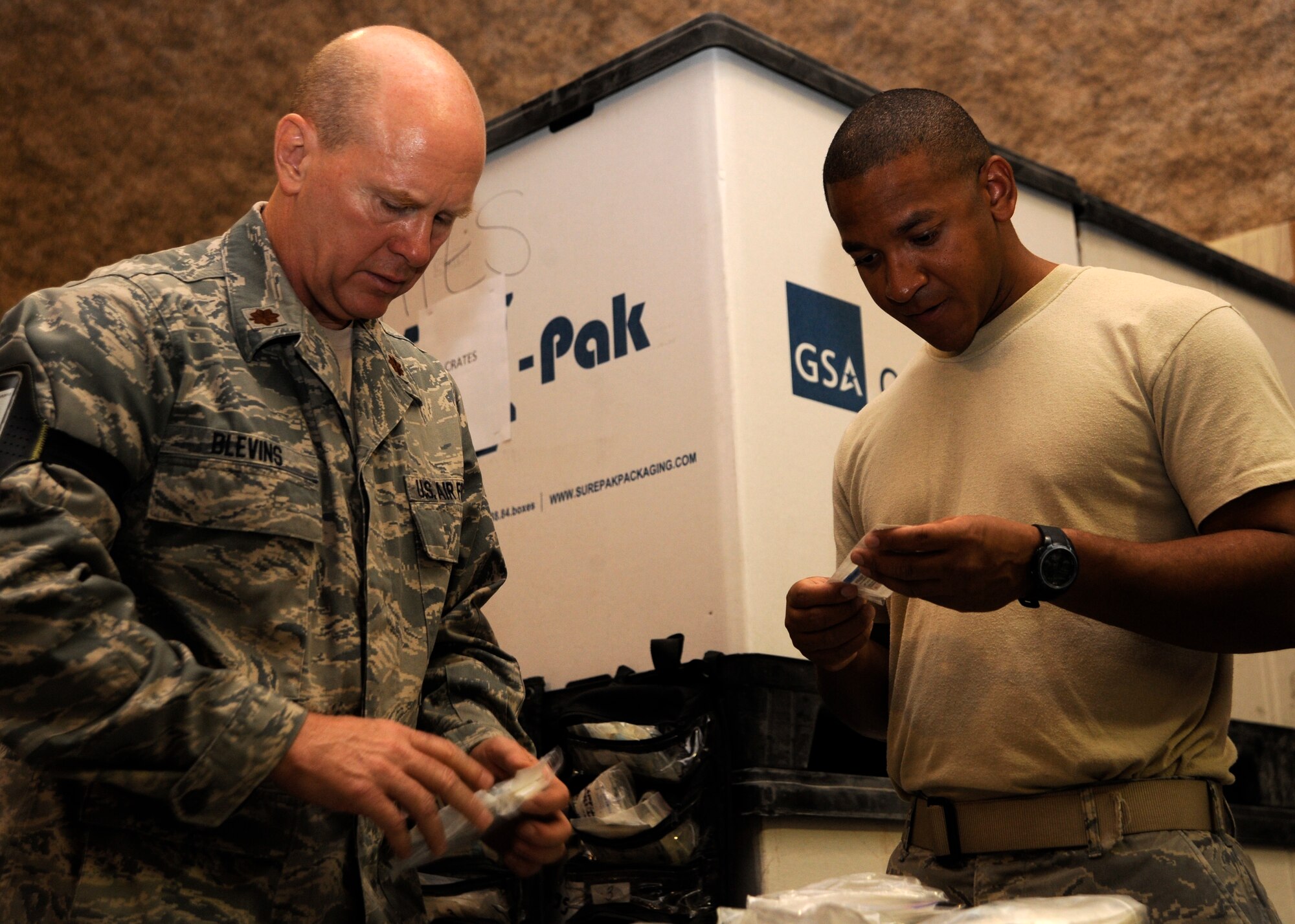 Maj. Steve Blevins and Staff Sgt. Charles Orphe organize medical kits after a Mobile Field Medical Team and Expeditionary Critical Care Team exercise at the 379th Air Expeditionary Wing in Southwest Asia, Sept. 6, 2013. Blevins is a 379th Expeditionary Medical Operations Squadron MFST operation room nurse deployed from Joint Base Langley-Eustis, Va., and a Yorktown Va., native. Orphe is a 379th EMDOS MFST surgical technician deployed from Nellis Air Force Base, Nev., and hails from St. Martinville, La. (U.S. Air Force photo/Senior Airman Bahja J. Jones)  