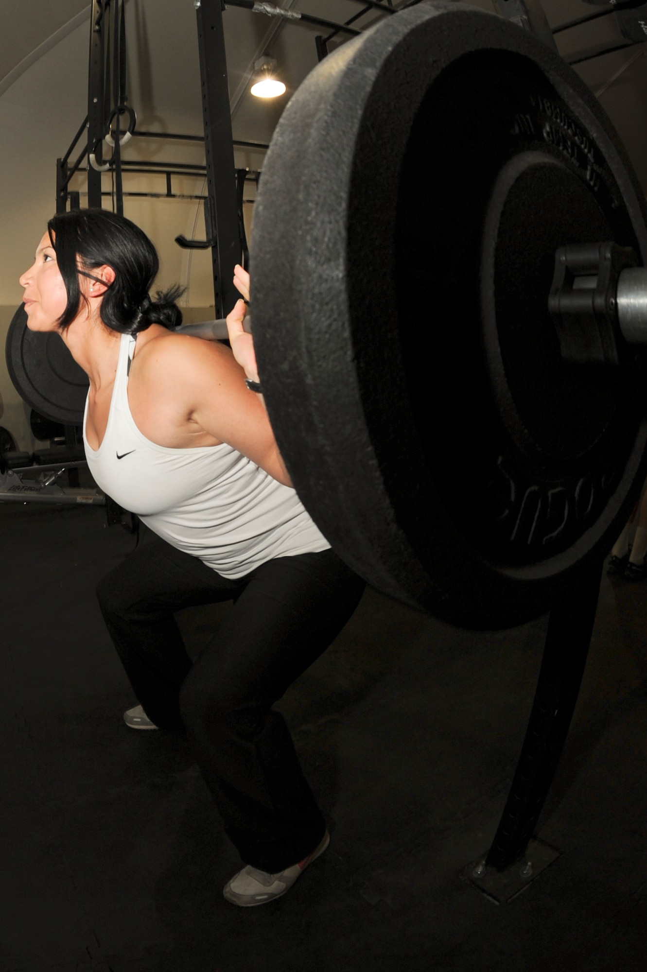 U.S. Air Force Staff Sgt. Vanessa Wyatt, 380th Expeditionary Civil Engineer Squadron, performs squats during a workout at an undisclosed location in Southwest Asia Sept. 11, 2013. Wyatt recently took second place in AFCENT's bi-annual "Strongest in the AOR" competition where she lifted a total of 650 pounds. Wyatt competed in three exercises for the competition; squat, bench press and deadlift. Wyatt is native to Orange, Calif., and is deployed from Nellis Air Force Base, Nev. (U.S. Air Force photo by Staff Sgt. Joshua J. Garcia)