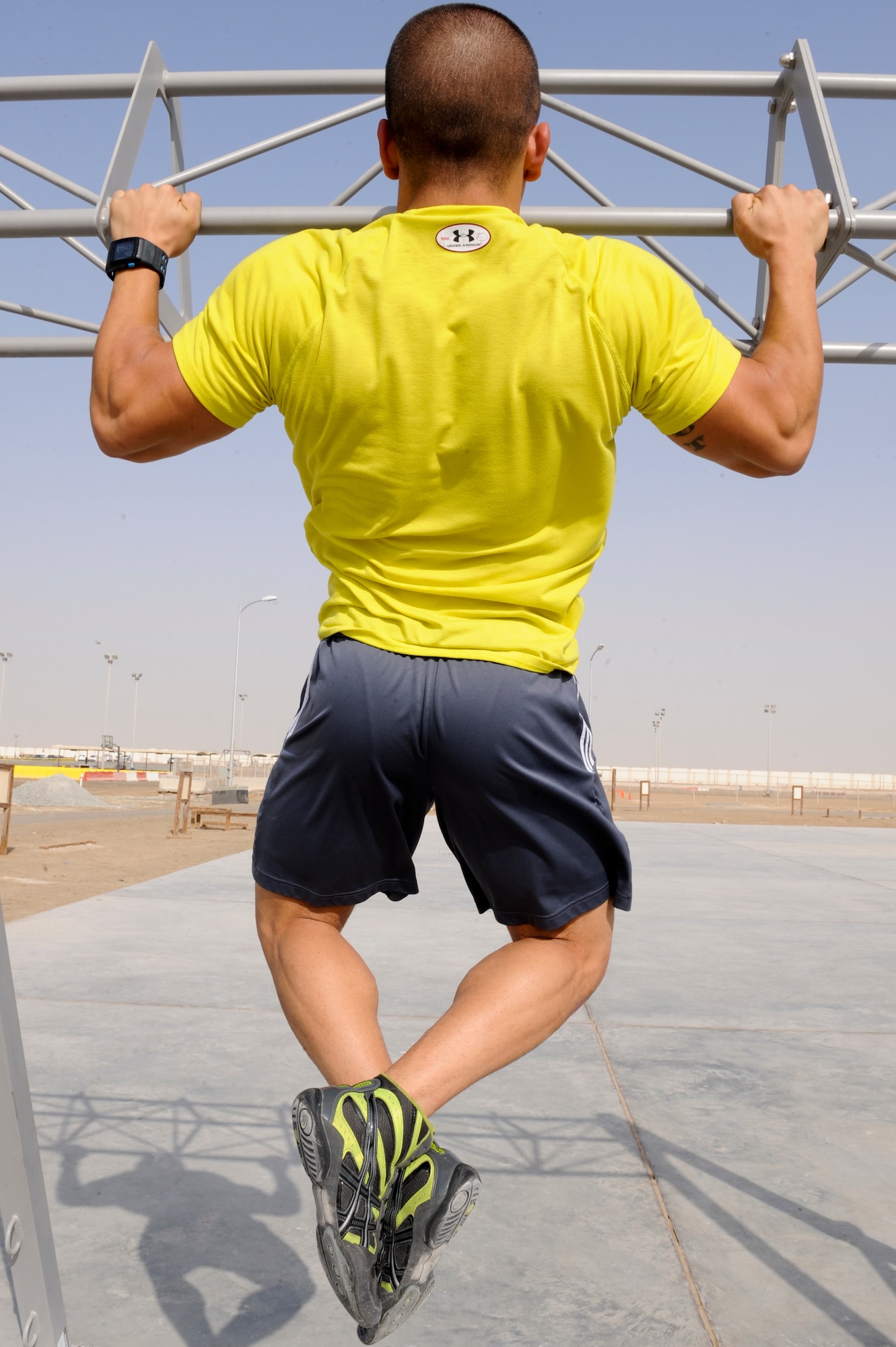 U.S. Air Force Senior Airman Brandon Stout, 380th Expeditionary Civil Engineer Squadron, does pull ups during a workout at an undisclosed location in Southwest Asia Sept. 11, 2013. Stout recently took first place in AFCENT's bi-annual "Strongest in the AOR" competition where he lifted a total of 1,460 pounds. Stout competed in three exercises for the competition; squat, bench press and deadlift. Stout is native to Holly, Mich., and is deployed from Ellsworth Air Force Base, S.D. (U.S. Air Force photo by Staff Sgt. Joshua J. Garcia)