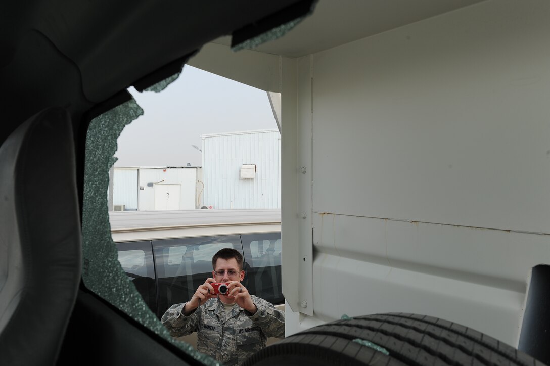 Staff Sgt. Eric Mantle documents damage to a government vehicle at an undisclosed location in Southwest Asia.  He is the lease contract office representative as well as the vehicle control function manager at the 386th Expeditionary Logistics Readiness Squadron.  Mantle is deployed from Malmstrom Air Force Base, Mont.  This is his second deployment and first as a husband and father.  He has been selected by his leadership as this week's Rock Solid Warrior.  (U.S. Air Force photo by Master Sgt. Marelise Wood)