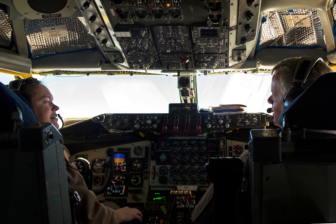U.S. Air Force Maj. Abby Kent, left, and U.S. Air Force Lt. Col. Jerry Selig talk in the cockpit of a KC-135 Stratotanker aircraft during an air refueling mission over Afghanistan, Sept. 4, 2013. Kent and Selig, pilots, are assigned to the 340th Expeditionary Air Refueling Squadron.