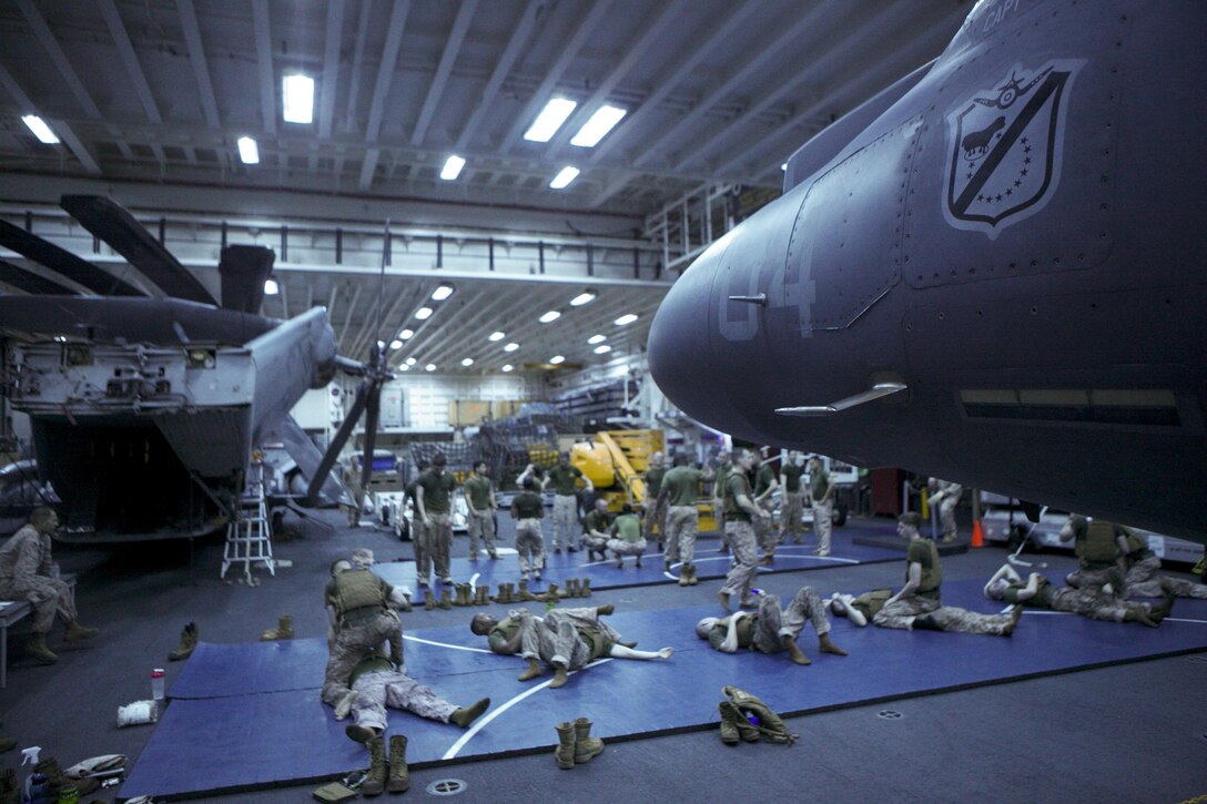 Marines and Sailors with the 31st Marine Expeditionary Unit conduct Marine Corps Martial Arts training in the hanger bay here, Sept. 12. Those participating in the MCMAP training have to work around the challenges that being deployed on an amphibious warship presents, including time limitations, confined space, dim lighting and unstable fighting grounds. The 31st MEU is the Marine Corps’ force in readiness in the Asia-Pacific region and is the only continuously forward deployed MEU. 