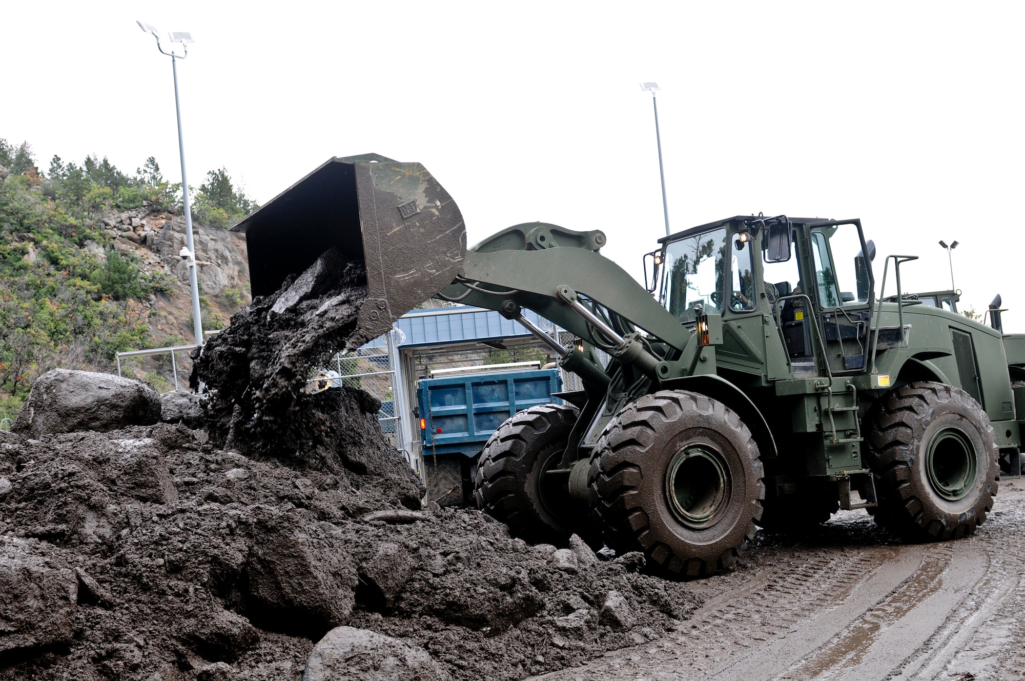 CHEYENNE MOUNTAIN AFS, Colo. -- Spc. Donald Townsend, heavy equipment operator, 615th Engineer Company, 52nd Engineer Battalion, uses his bulldozer to move large amounts of debris at the Cheyenne Mountain Air Force Station, Sept. 13, 2013. The 615th Eng. is part of the severe weather reaction team and responded to a catastrophic mudslide on the AFS. (U.S. Army photo by Sgt. William Smith, 4th Inf. Div. PAO)
