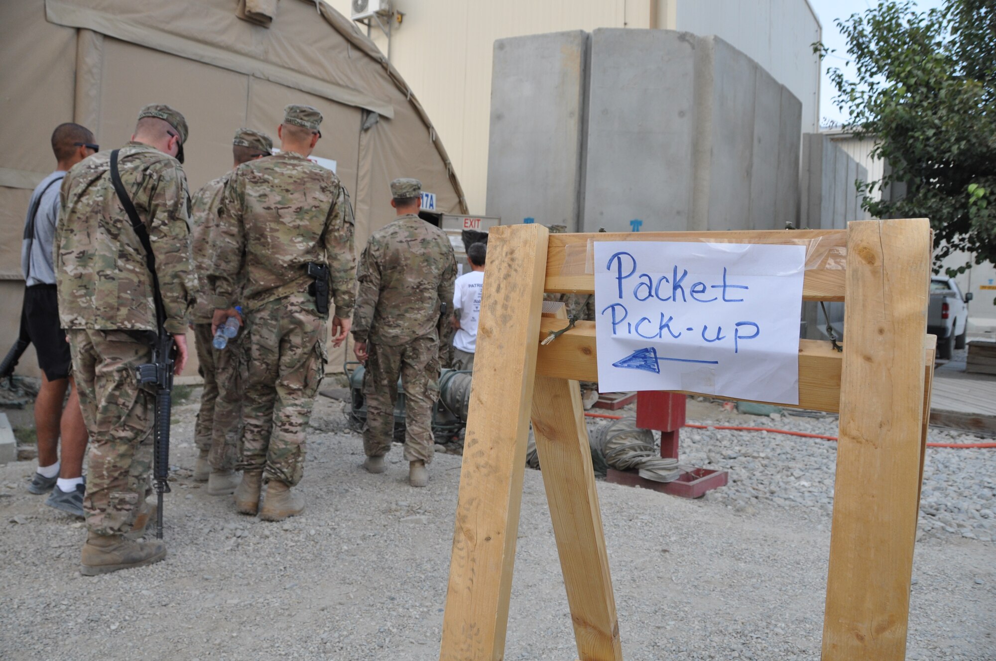 Participants pick up their race packets and t-shirts during a block party at Bagram Airfield, Afghanistan. More than 700 people participated in the 3rd annual Bagram Marathon events held here Sept. 15, 2013. The Bagram Marathon is an extension of the Air force Marathon held at Wright Patterson Air Force Base, in Dayton, Ohio, Sept. 21. Bagram is one of seven deployed locations throughout the area of responsibility that participated in the extension races. (U.S. Air Force photo/Tech. Sgt. Rob Hazelett)