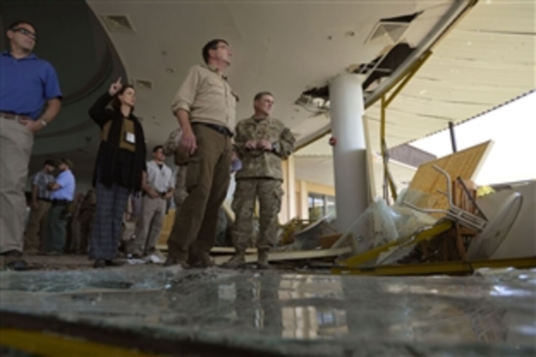 U.S. Deputy Defense Secretary Ash Carter, center, looks over the damage to the U.S. Consulate in Herat, Afghanistan, Sept. 14, 2013. Consulate personnel fought off an attack by the Taliban a day earlier.
