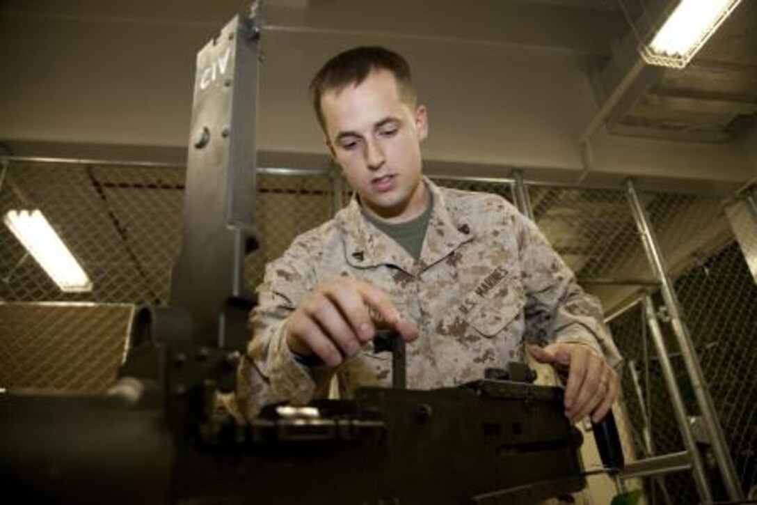 Cpl. Jason D. Dospoy assesses parts of an M2 .50-caliber Browning machine gun during a limited technical inspection April 22 at the armory on Camp Foster. Assessing weapons allows small-arms repairers and technicians to determine how problems should be fixed. Dospoy is a small-arms repairer and technician with Headquarters and Service Battalion, Marine Corps Base Camp Smedley D. Butler, Marine Corps Installations Pacific.