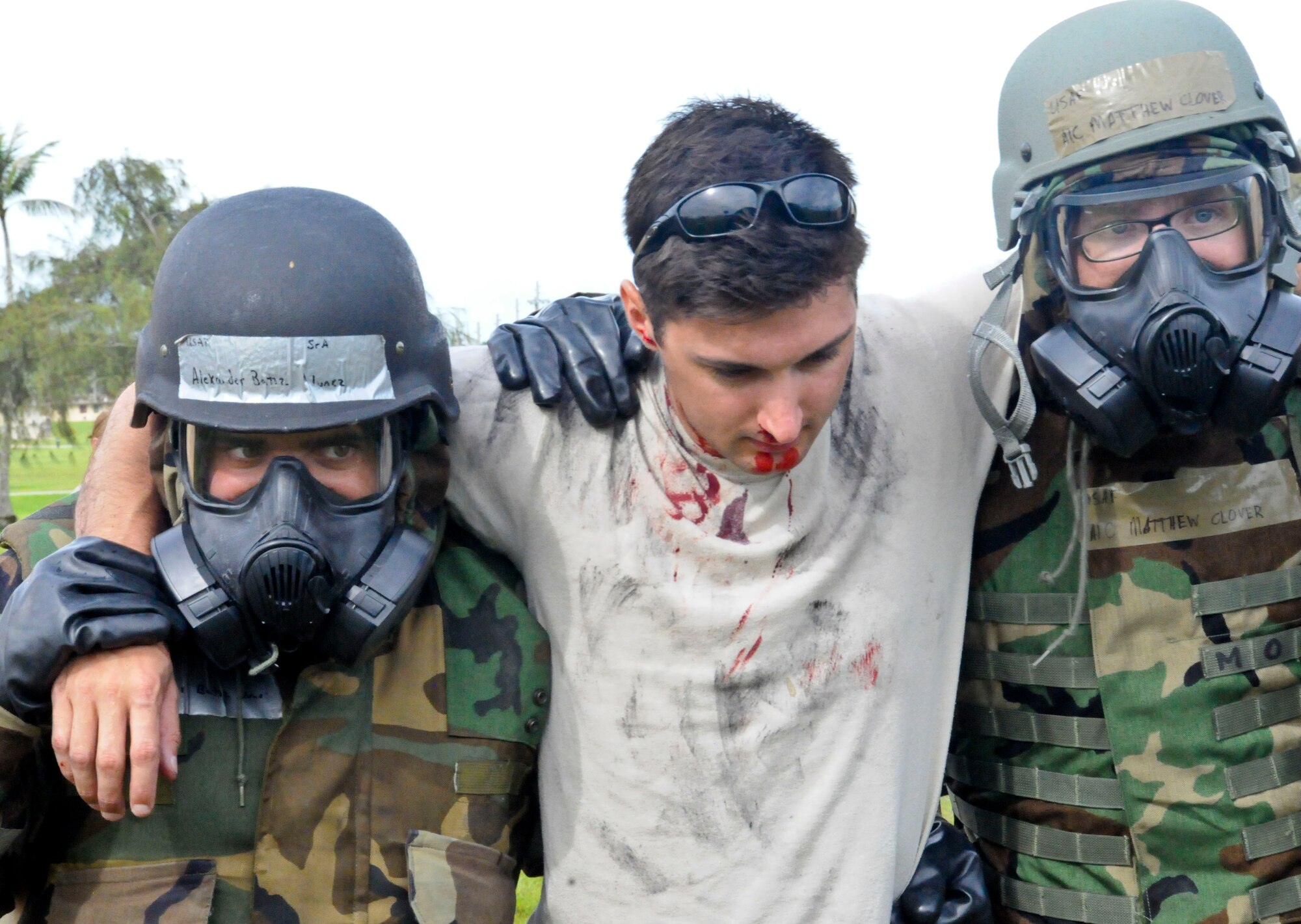 Airmen perform a two-man carry during a self-aid buddy care simulation at the Ability to Survive and Operate Rodeo Sept. 13, 2013, on Andersen Air Force Base, Guam. Airmen are required to demonstrate their wartime skills in heightened awareness situations during the rodeo.( (U.S. Air Force photo by Airman 1st Class Amanda Morris/Released)