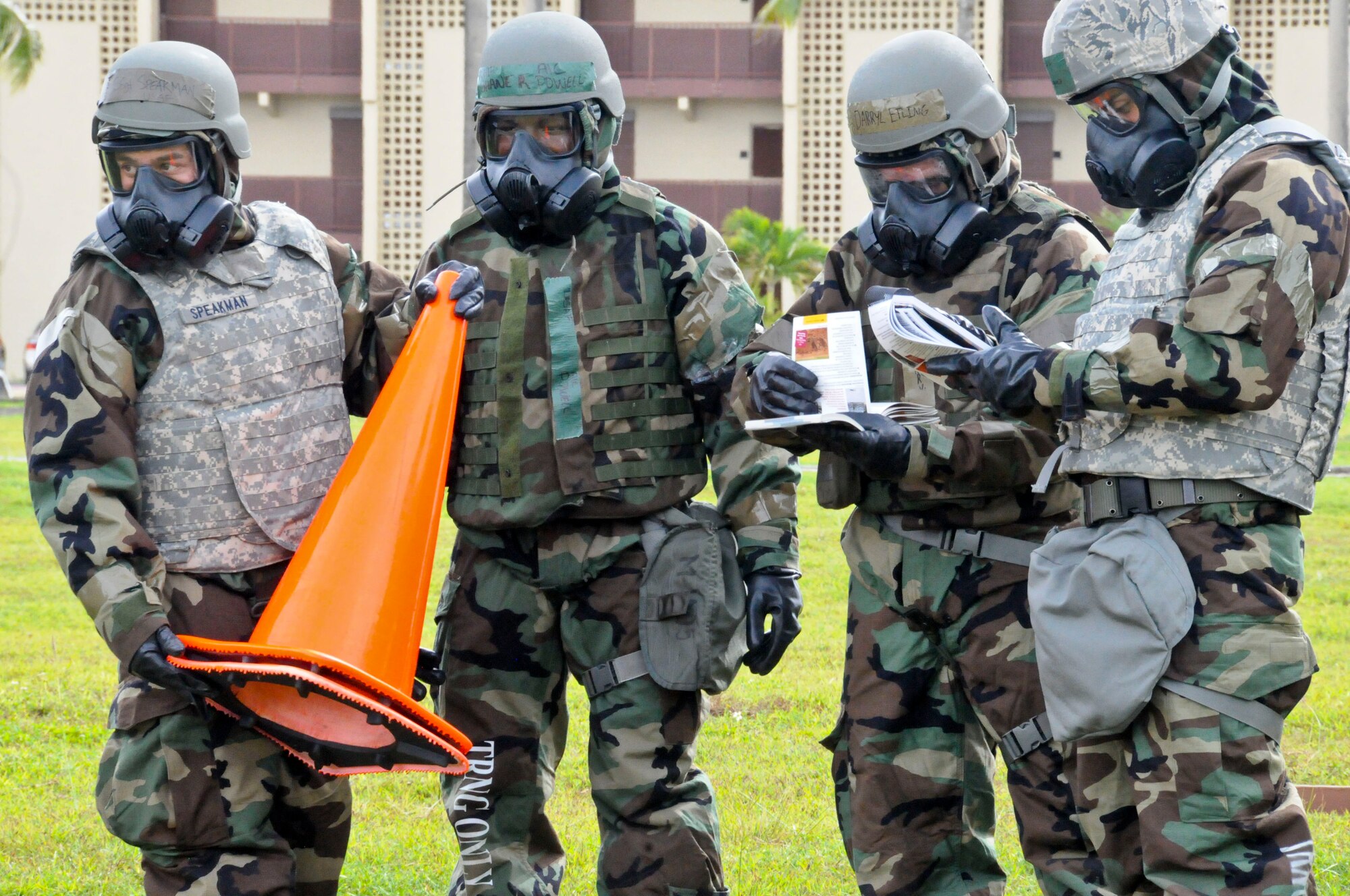 Airmen simulate a post-attack reconnaissance sweep during the Ability to Survive and Operate Rodeo Sept. 13, 2013, on Andersen Air Force Base, Guam. Areas of focus during the rodeo ranged from decontamination, transition points, chemical gear wear, self-aid buddy care, unexploded ordnance identification and land-mobile radio use. (U.S. Air Force photo by Airman 1st Class Amanda Morris/Released)