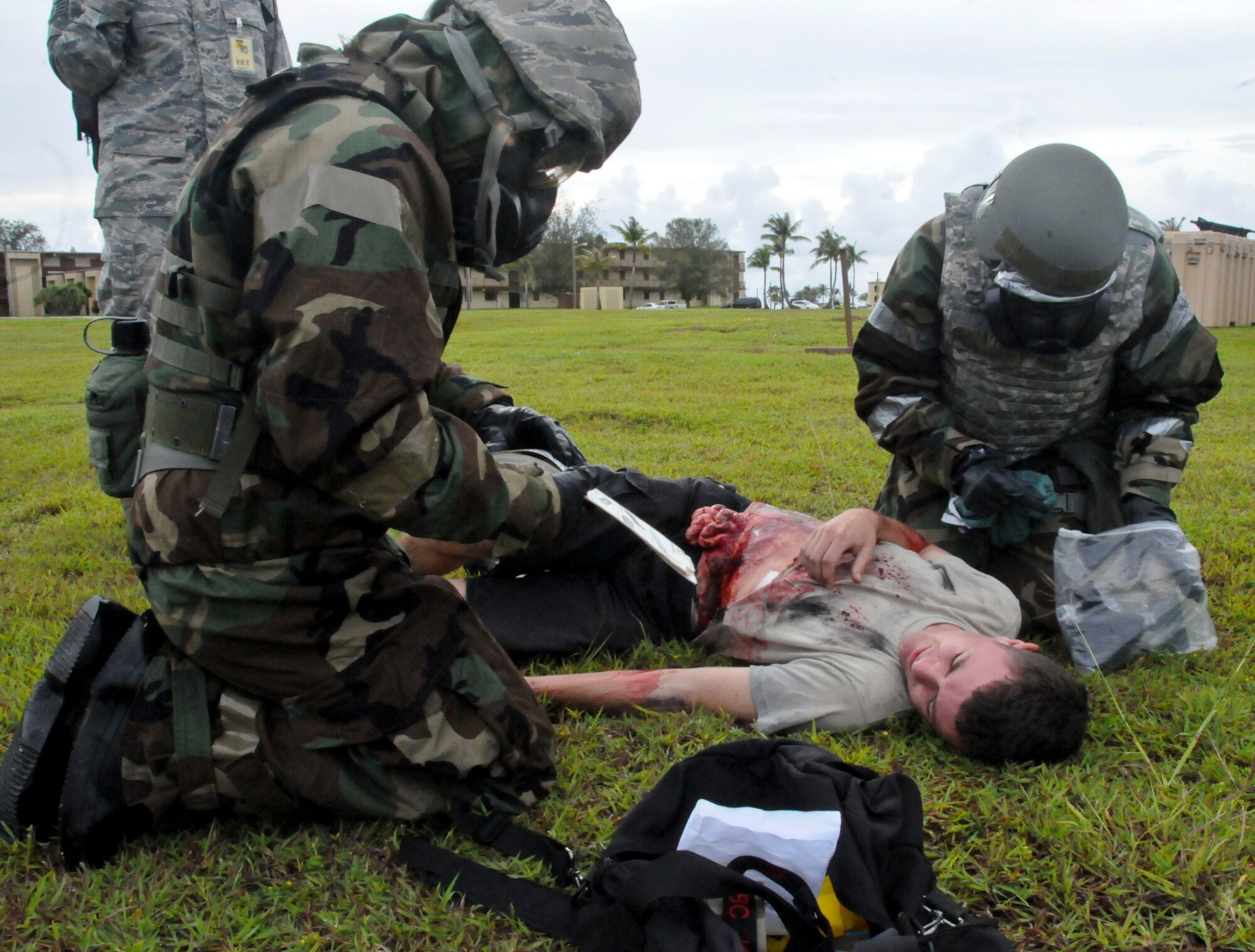 Airmen perform exercise scenario self-aid buddy care during the Ability to Survive and Operate Rodeo Sept. 13, 2013, on Andersen Air Force Base, Guam. Exercise evaluation team members graded participants on their ability to demonstrate wartime skills in preparation for real-world contingencies throughout the rodeo.  (U.S. Air Force photo by Airman 1st Class Amanda Morris/Released) 