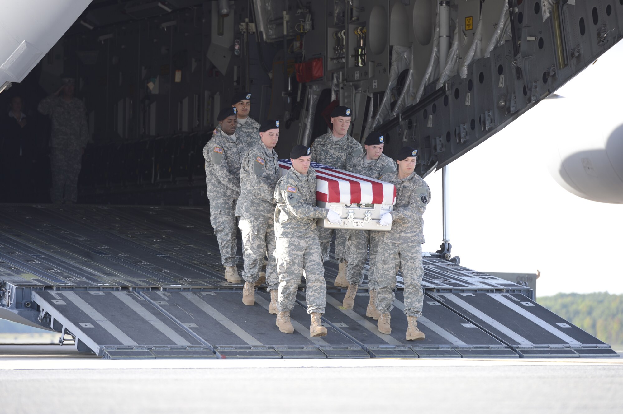 A U.S. Army carry team transfers the remains of Staff Sgt. Randall R. Lane, of Indianapolis, Ind., during a dignified transfer Sept. 15, 2013 at Dover Air Force Base, Del. Lane was assigned to the 1438th Transportation Company, Indiana Army National Guard, Indianapolis, Ind. (U.S. Air Force photo/Greg L. Davis)