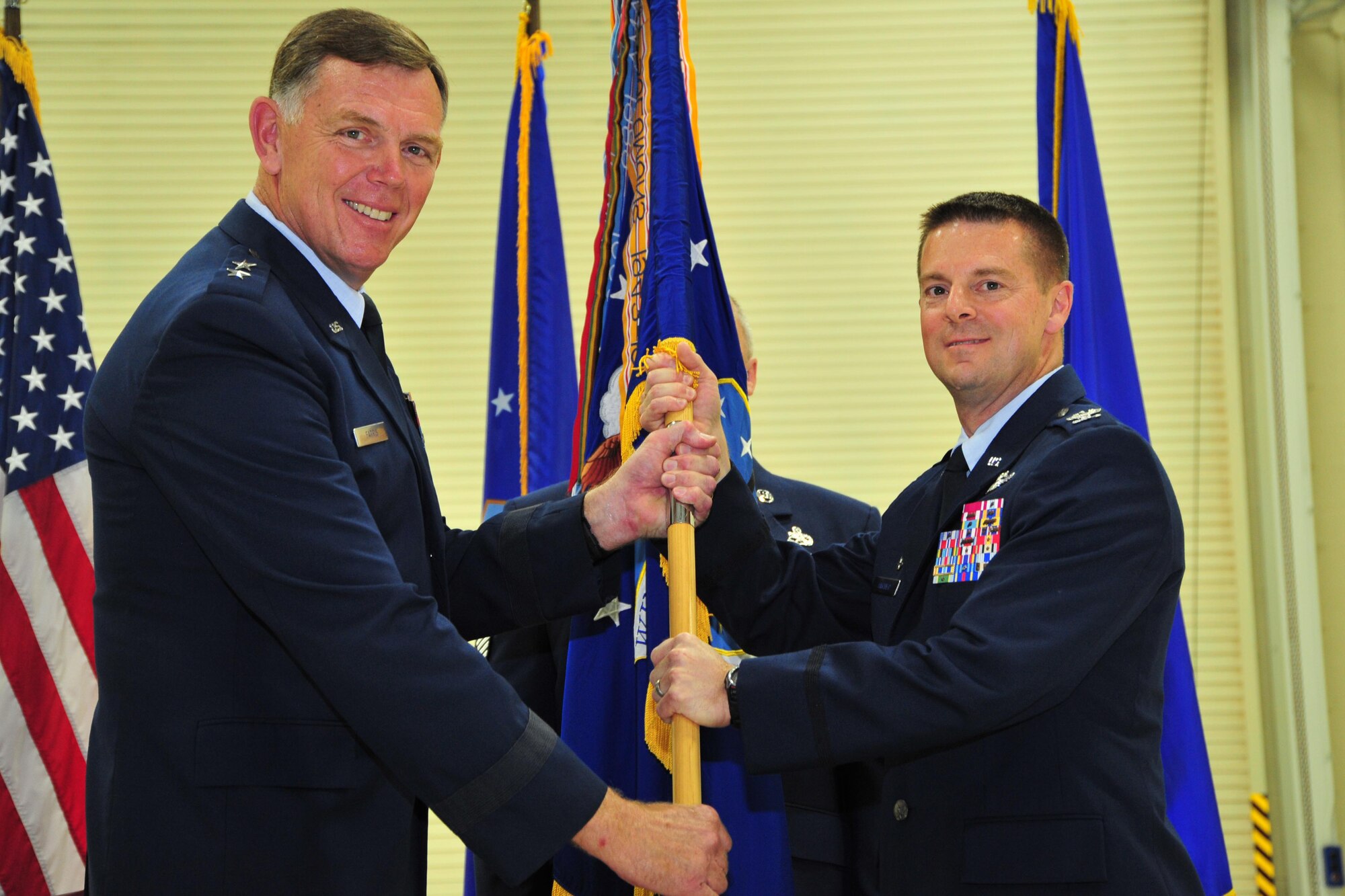 Major General Wallace “Wade” Farris Jr., 22nd Air Force commander, passes the 403rd Wing guidon to Col. Frank Amodeo, 403rd wing commander, during an assumption of command ceremony held at Keesler Air Force Base, Miss. Amodeo assumed command of the 403rd Wing at the ceremony, which was held Sept. 14, 2013. (U.S. Air Force photo/Tech. Sgt. Ryan Labadens)