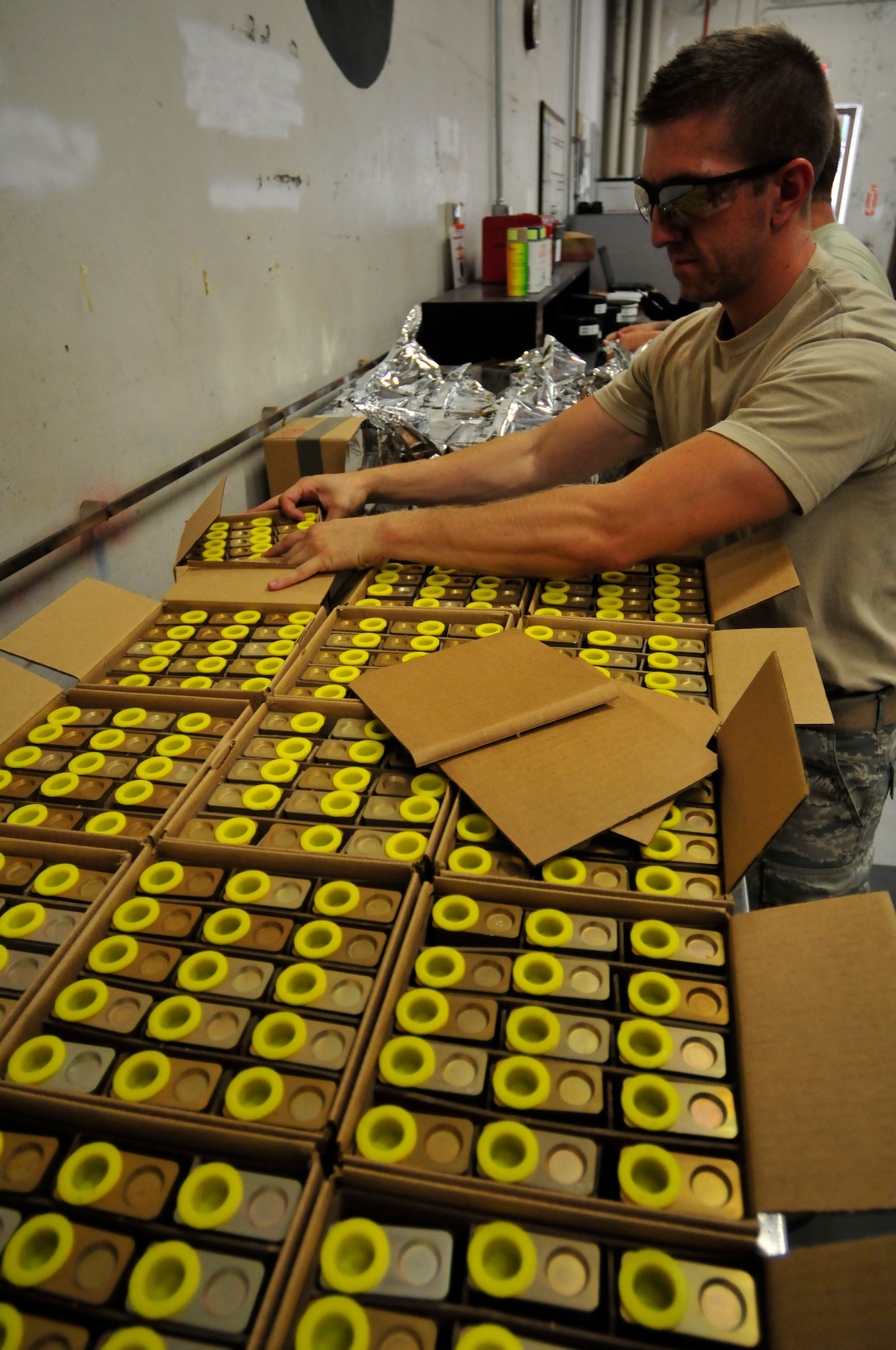 U.S. Air National Guard Senior Airman Chad Woodward, equipment ordinance mechanic for the 125th Fighter Wing, unpacks flares from there transportation crates during a 'flare build' at Jacksonville IAP, Fla. on Sept. 14, 2013. During this particular build, 1080 flares were assembled by several U.S. Air National Guard Airmen in under an hour and made ready for the F-15 fighting mission. U.S. Air National Guard Photo by Staff Sgt. Jeremy Brownfield. Released.