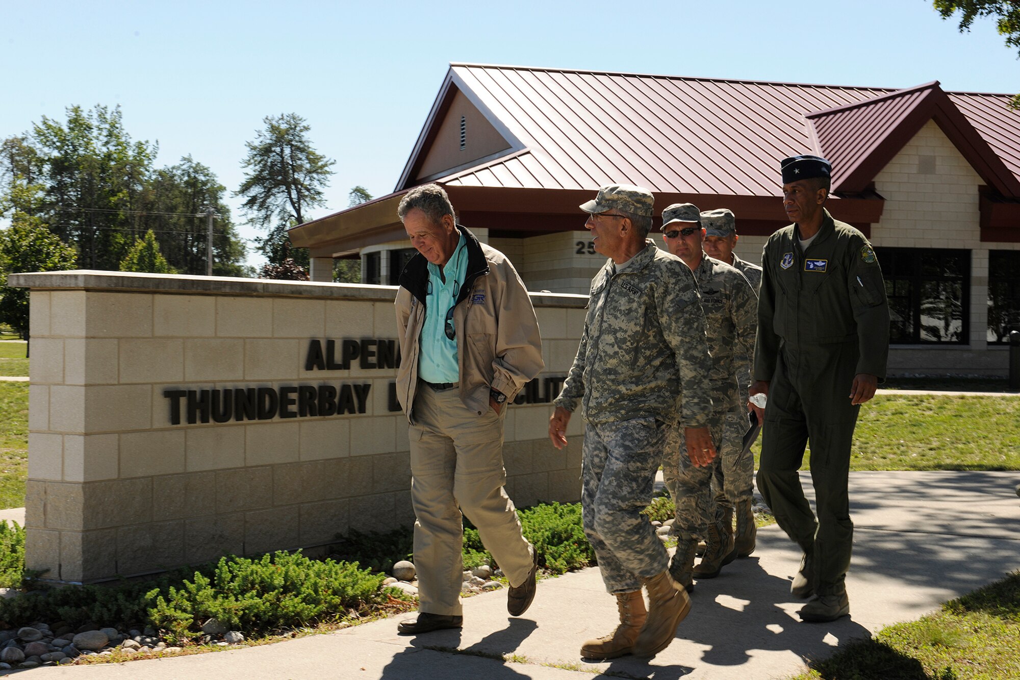 130913-Z-EZ686-250 – Lt. Gen. (ret.) Dennis McCarthy, chairman of the National Commission of the Structure of the Air Force, walks with Major Gen. Gregory Vadnais, the adjutant general of Michigan; Brig. Gen. Leonard Isabelle, commander of the Michigan Air National Guard; and other officers outside while on a visit to the Alpena Combat Readiness Training Center in Alpena, Mich., Sept. 13, 2013. McCarthy visited Alpena and Selfridge Air National Guard Base during the trip. (U.S. Air National Guard photo by MSgt. David Kujawa/Released)