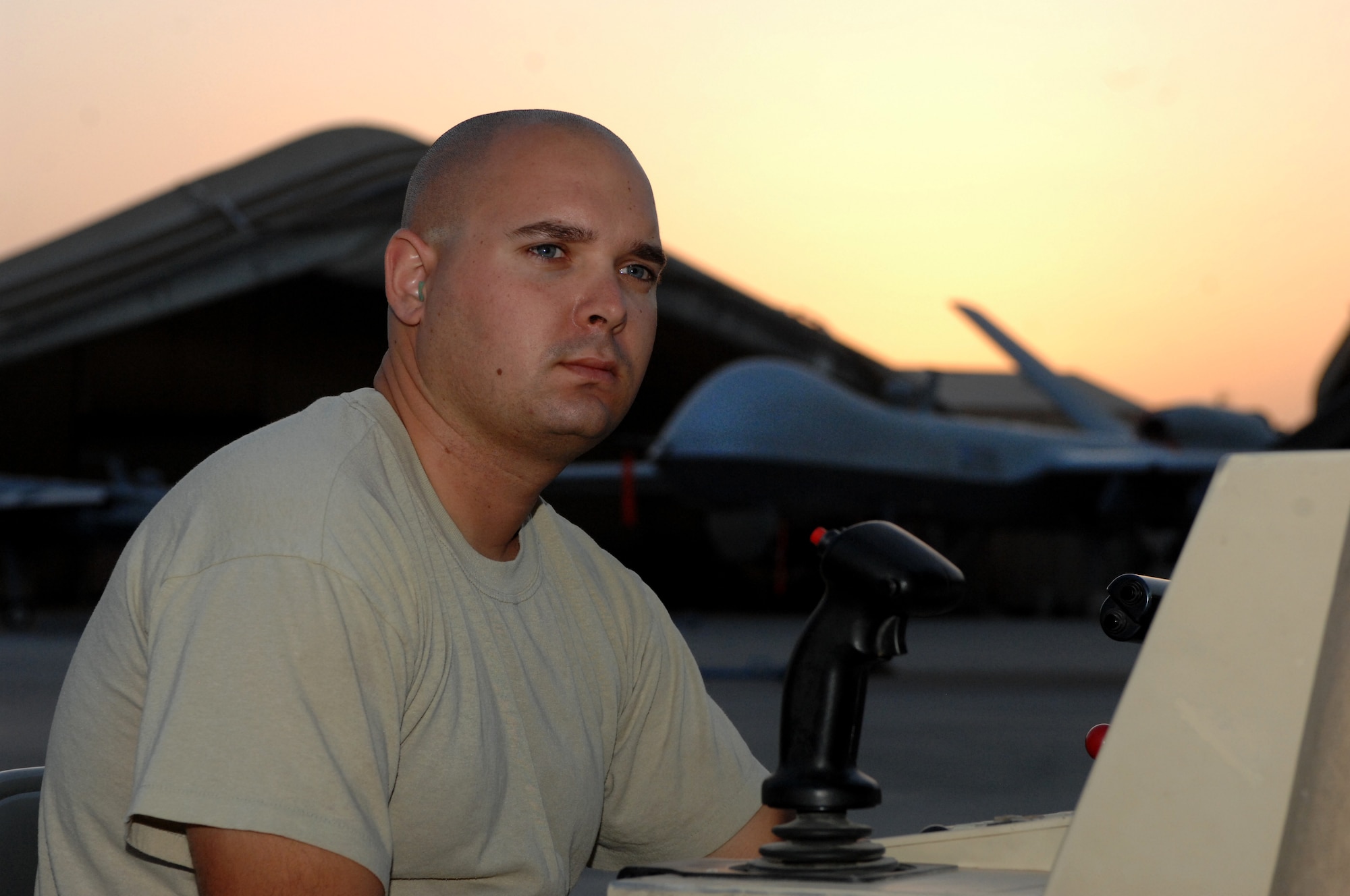 Staff Sgt. Timothy Rau, 451st Expeditionary Aircraft Maintenance Squadron dedicated crew chief,  sits at a remote control terminal for the MQ-9 Reaper to test equipment before a launch Aug. 27, 2013, at Kandahar Airfield, Afghanistan. Members of the 451st are responsible for maintenance, launch and recovery for MQ-1 and MQ-9 aircraft. (U.S. Air Force photo/Senior Airman Jack Sanders)