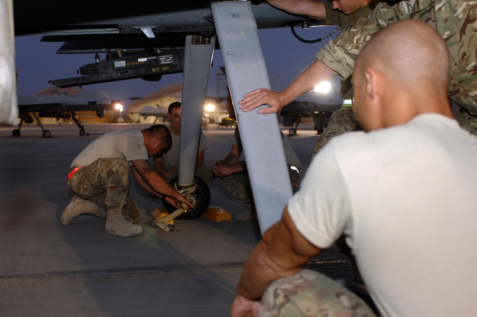 Airmen from the 451st Expeditionary Aircraft Maintenance Squadron secure an MQ-9 Reaper in preparation for a mission Aug. 27, 2013 at Kandahar Airfield, Afghanistan. Members of the 451st EAMXS are responsible for maintenance, launch and recovery for MQ-1 and MQ-9 aircraft. (U.S. Air Force photo/Senior Airman Jack Sanders)
