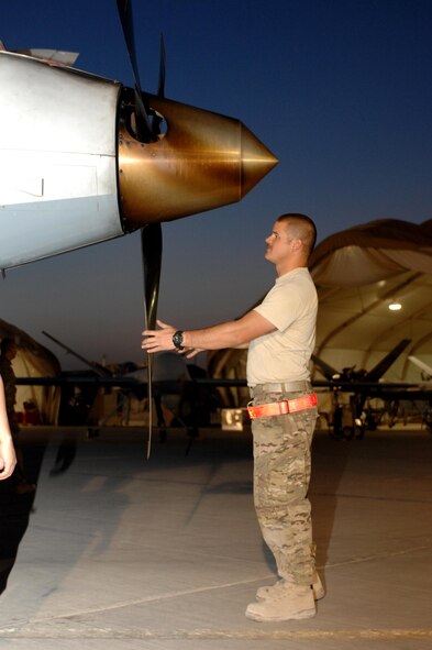 Staff Sgt. Tyler Groff, 451st Expeditionary Aircraft Maintenance Squadron dedicated crew chief, checks the propeller of an MQ-9 Reaper before a flight Aug. 27, 2013, at Kandahar Airfield, Afghanistan. Members of the 451st EAMXS are responsible for maintenance, launch and recovery for MQ-1 and MQ-9 aircraft.