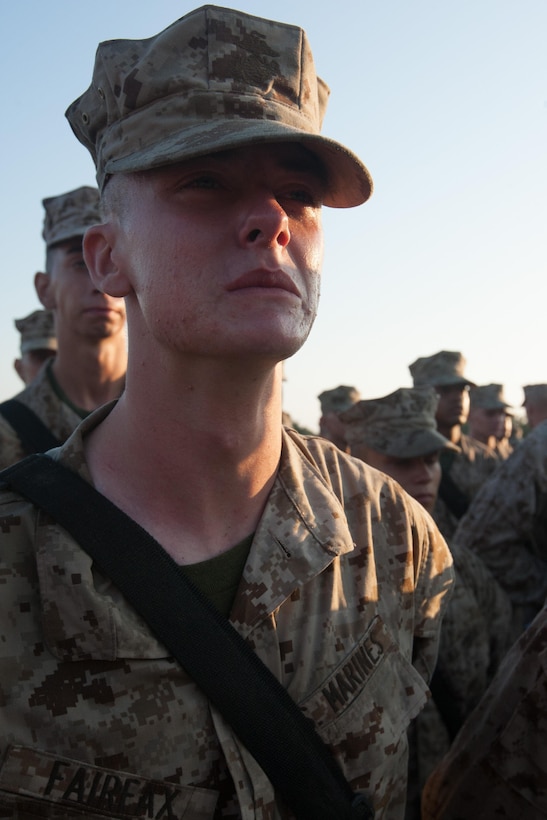 Rct. David Fairfax, Platoon 1068, Delta Company, 1st Recruit Training Battalion, waits to receive his Eagle, Globe and Anchor during the emblem ceremony Sept. 7, 2013, at the Iwo Jima flag raising statue on Parris Island, S.C. This ceremony has been a tradition since the first Crucible in 1996. Fairfax, an 18-year-old native of Weymouth, Mass., is scheduled to graduate Sept. 13, 2013. Parris Island has been the site of Marine Corps recruit training since Nov. 1, 1915. Today, approximately 20,000 recruits come to Parris Island annually for the chance to become United States Marines by enduring 13 weeks of rigorous, transformative training. Parris Island is home to entry-level enlisted training for 50 percent of males and 100 percent for females in the Marine Corps. (Photo by Lance Cpl. MaryAnn Hill)