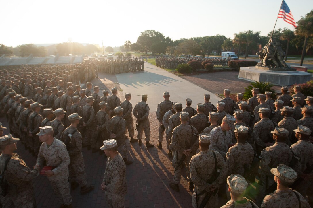 Drill instructors of Delta Company, 1st Recruit Training Battalion, and Papa Company, 4th Recruit Training Battalion, present their new Marines with Eagle, Globe and Anchors during the emblem ceremony Sept. 7, 2013, at the Iwo Jima flag raising statue on Parris Island, S.C. This ceremony marks the end of the 54-hour culminating event of training known as the Crucible and is the first time recruits are called Marines. Delta and Papa Companies are scheduled to graduate Sept. 13, 2013. Parris Island has been the site of Marine Corps recruit training since Nov. 1, 1915. Today, approximately 20,000 recruits come to Parris Island annually for the chance to become United States Marines by enduring 13 weeks of rigorous, transformative training. Parris Island is home to entry-level enlisted training for 50 percent of males and 100 percent for females in the Marine Corps. (Photo by Lance Cpl. MaryAnn Hill)