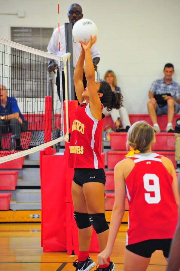 Melissa, senior, returns a volleyball during a game against Emmanuel Christian School at the Quantico Middle/High School gym on Sept. 9, 2013. The Lady Warriors beat their opponent maintaining their undefeated 2013 record.