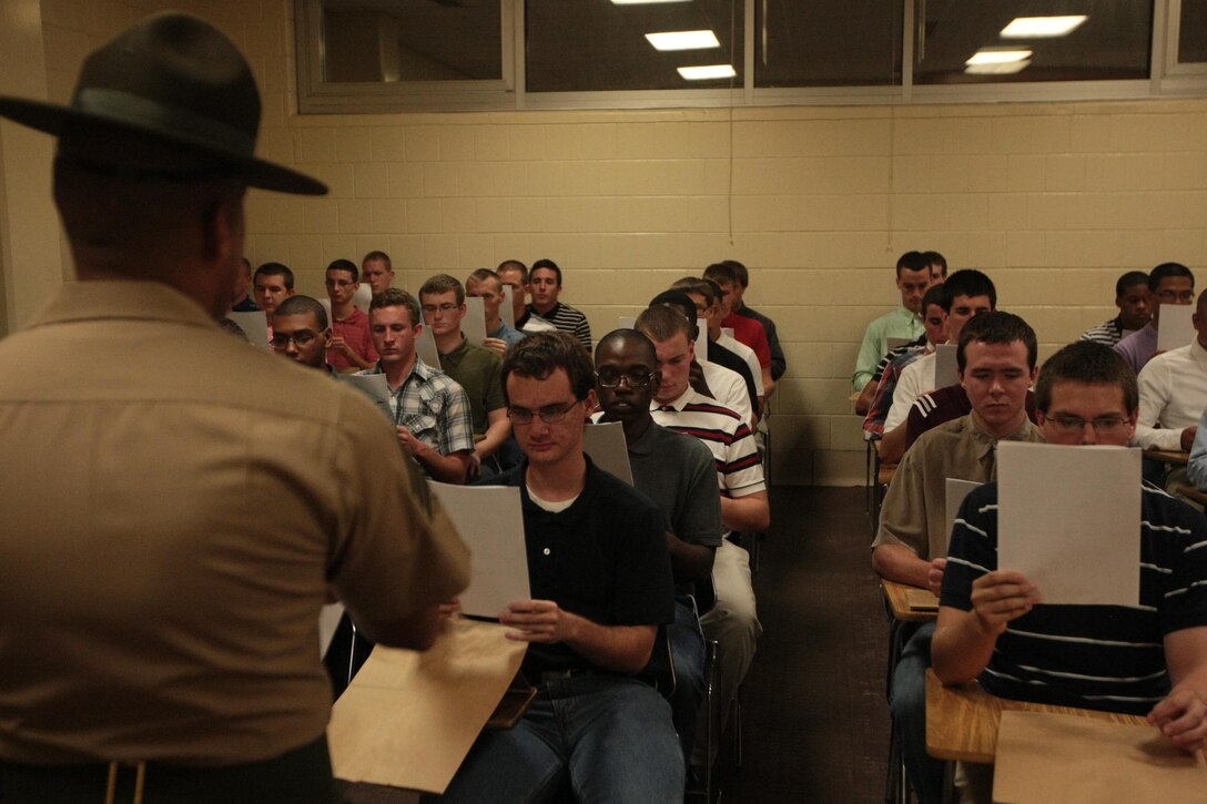 New recruits of Kilo Company, 3rd Recruit Training Battalion, begin filling out in-processing paperwork shortly after arriving on Parris Island, S.C., for Marine Corps recruit training Aug. 26, 2013. The recruits spent the night completing paperwork and receiving haircuts and gear in preparation for the next 13 weeks. Kilo Company is scheduled to graduate Nov. 22, 2013. Parris Island has been the site of Marine Corps recruit training since Nov. 1, 1915. Today, approximately 20,000 recruits come to Parris Island annually for the chance to become United States Marines by enduring 13 weeks of rigorous, transformative training. Parris Island is home to entry-level enlisted training for 50 percent of males and 100 percent of females in the Marine Corps. (Photo by Cpl. Caitlin Brink)