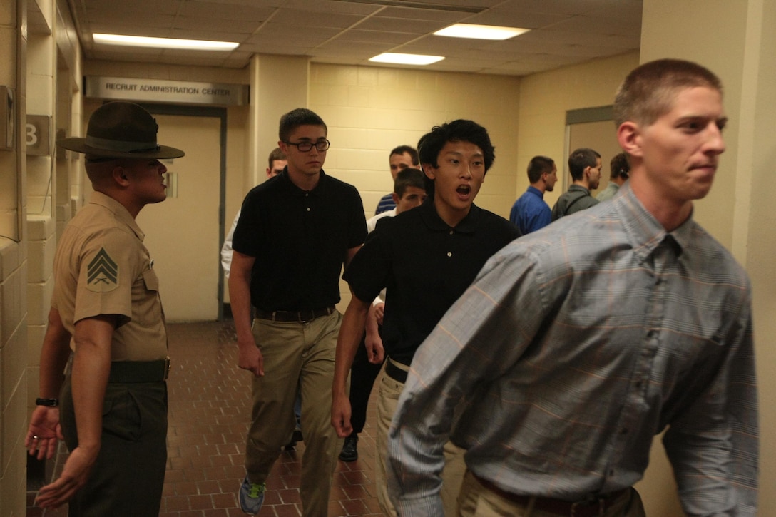 New recruits of Kilo Company, 3rd Recruit Training Battalion, rush to obey orders from Sgt. Mario Rodriguez, a drill instructor, after their arrival to Marine Corps recruit training on Parris Island, S.C., on Aug. 26, 2013. The first stressful night comes as a shock for most as they deal with sleep deprivation, new rules and ferocious drill instructors. Rodriguez, 24, from Azle, Texas, is one of a handful of drill instructors responsible for preparing new recruits for training. Kilo Company is scheduled to graduate Nov. 22, 2013. Parris Island has been the site of Marine Corps recruit training since Nov. 1, 1915. Today, approximately 20,000 recruits come to Parris Island annually for the chance to become United States Marines by enduring 13 weeks of rigorous, transformative training. Parris Island is home to entry-level enlisted training for 50 percent of males and 100 percent of females in the Marine Corps. (Photo by Cpl. Caitlin Brink)