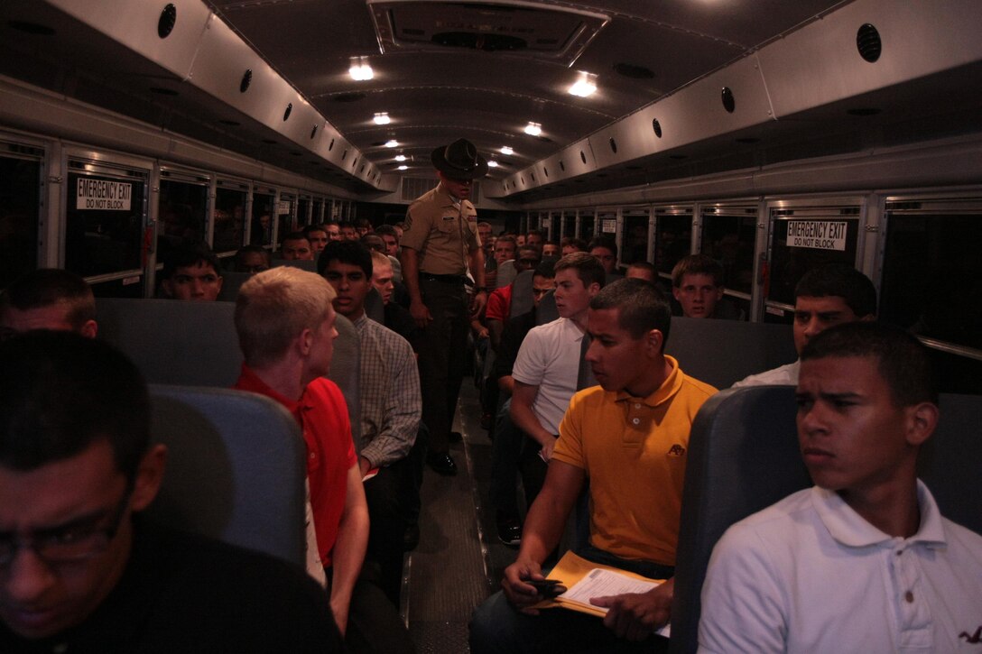 Staff Sgt. Carlos Vargas, a senior drill instructor, commands future recruits of Kilo Company, 3rd Recruit Training Battalion, to step off the bus and onto the yellow footprints Aug. 26, 2013, on Parris Island, S.C. The first stressful night comes as a shock for most as they deal with sleep deprivation, new rules and ferocious drill instructors. Vargas, 28, from Longmont, Colo., is one of a handful of drill instructors responsible for preparing new recruits for training. Kilo Company is scheduled to graduate Nov. 22, 2013. Parris Island has been the site of Marine Corps recruit training since Nov. 1, 1915. Today, approximately 20,000 recruits come to Parris Island annually for the chance to become United States Marines by enduring 13 weeks of rigorous, transformative training. Parris Island is home to entry-level enlisted training for 50 percent of males and 100 percent of females in the Marine Corps. (Photo by Cpl. Caitlin Brink)