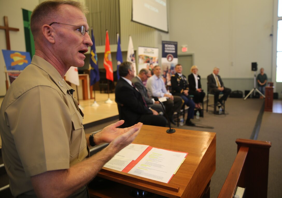 Commanding Officer of Marine Corps Air Station Yuma, Ariz., Col. Robert Kuckuk, moderates a panel of education leaders aboard Marine Corps Air Station Yuma, Ariz., Thursday. The town hall took place at the station chapel in front of a crowd of military parents and local teachers in order to address concerns and instill further confidence in the local military community. Topics included the rising costs of education and the challenges military children encounter through their academic career.