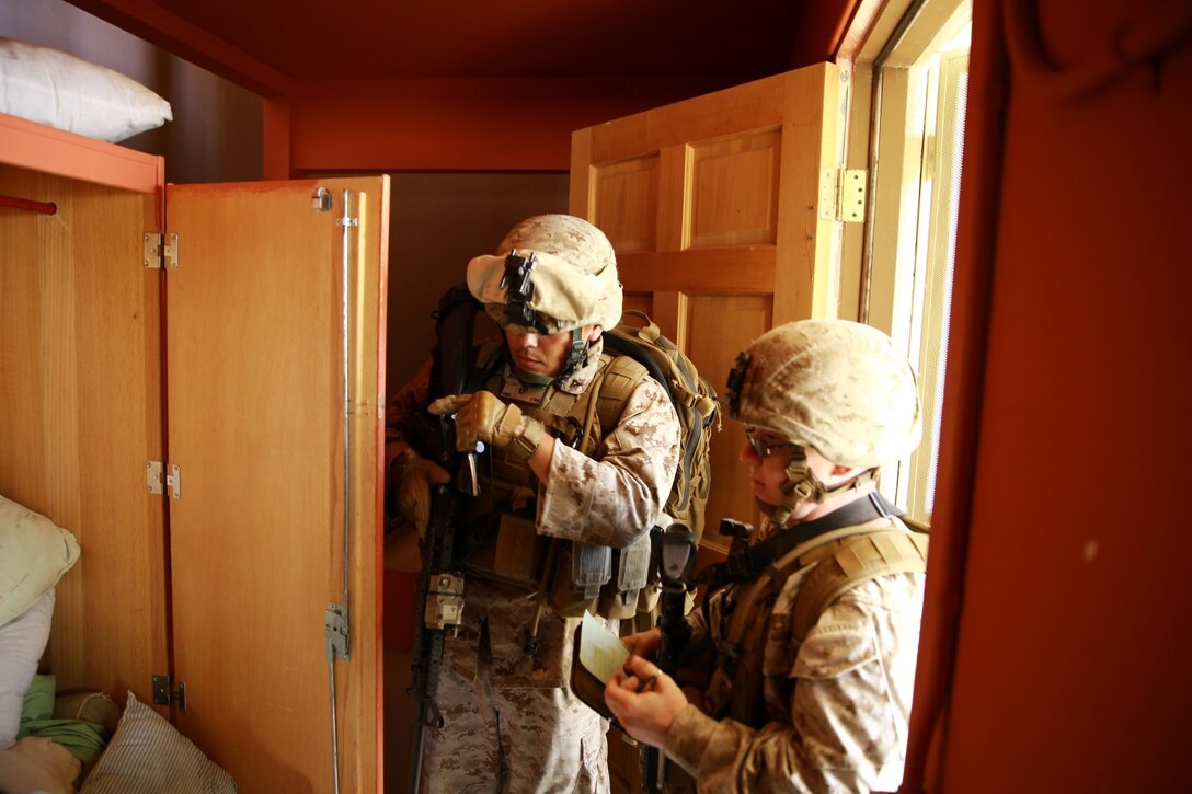 Marines serving with Headquarters Company, 3rd Battalion, 5th Marine Regiment, conduct a search for enemy weapons and intelligence during tactical sight exploitation training here, Sept. 11, 2013. The Marines interacted with role-players portraying possible enemy insurgents and conducted searches for enemy weapons and intelligence. The training was designed to prepare the Marines for their upcoming deployment with the 31st Marine Expeditionary Unit.