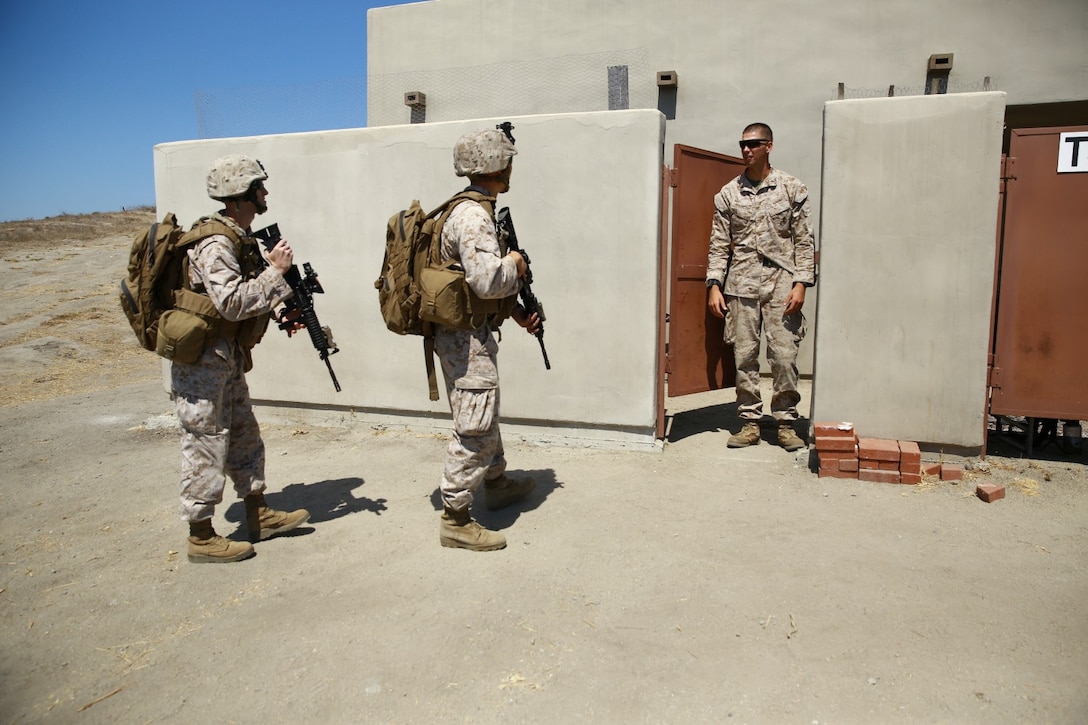 Marines serving with Headquarters Company, 3rd Battalion, 5th Marine Regiment, talk to a role-player portraying a possible enemy threat during tactical sight exploitation training here, Sept. 11, 2013. After securing the perimeter, the Marines gained entry into the role-player's house and searched it for weapons and intelligence. The training was designed to prepare the Marines for their upcoming deployment with the 31st Marine Expeditionary Unit.